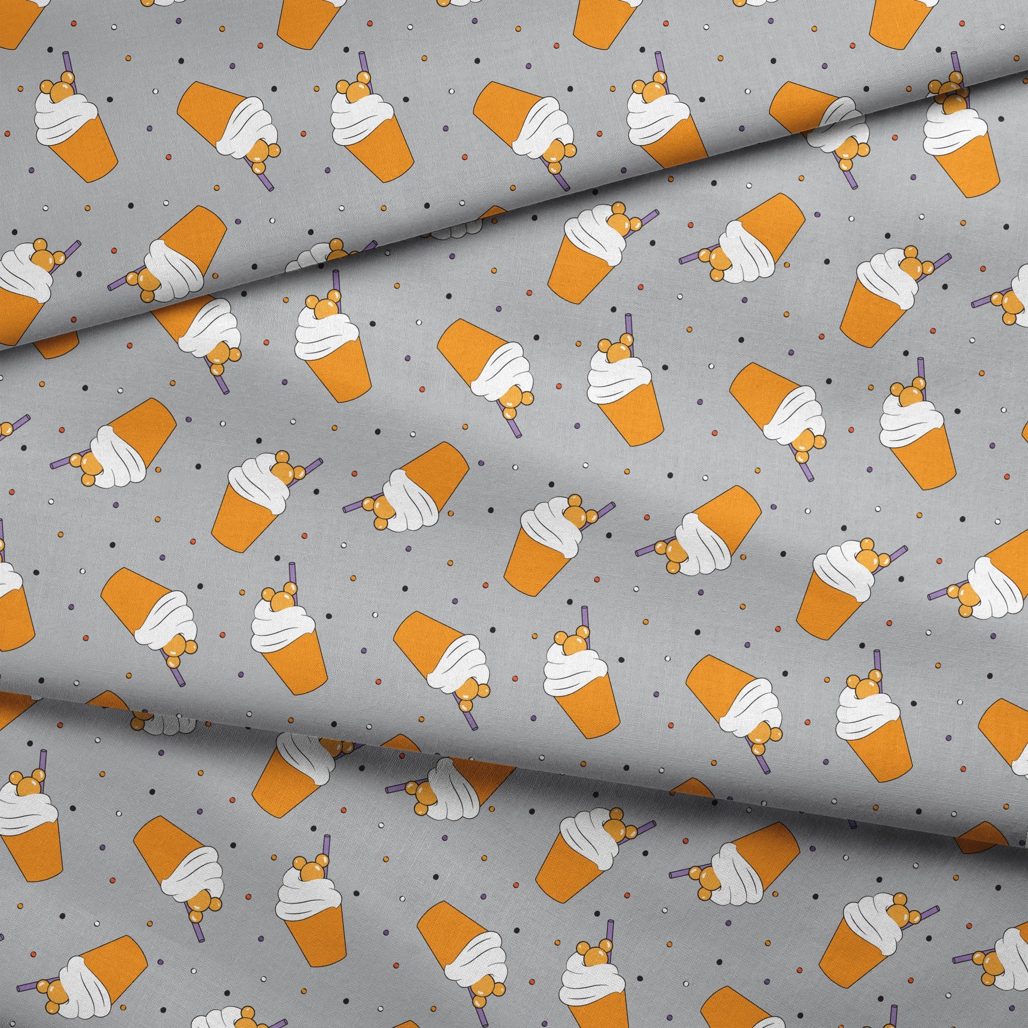 Orange Disney-inspired drinks with whipped cream and purple straws on gray background with colorful dots fabric fold mockup