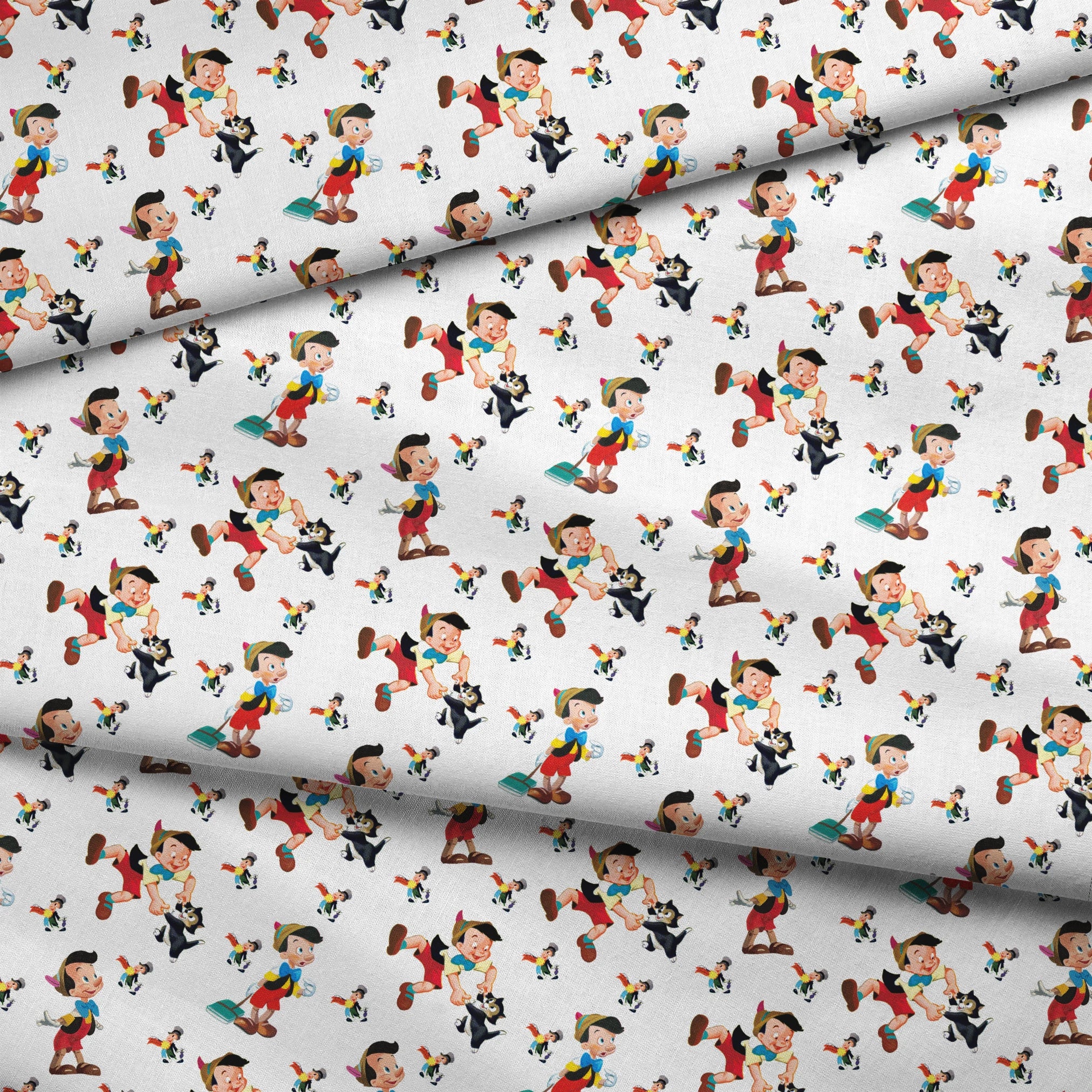 Pattern of cartoon wooden puppet characters with long noses, red shorts, blue bow ties, and black cats scattered on white background fabric fold mockup