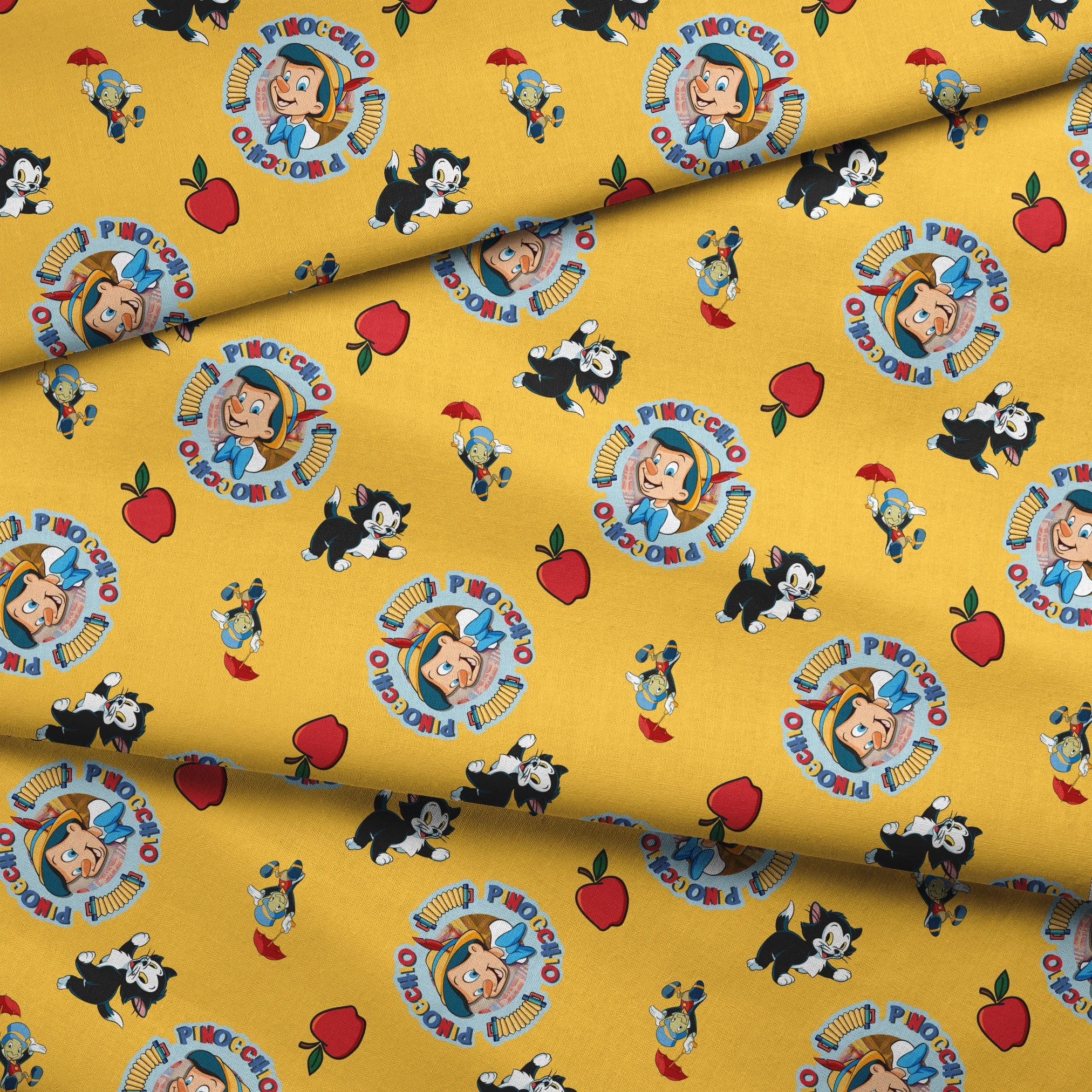 Pinocchio and Disney character pattern on yellow background with circular logos and red apples fabric fold mockup