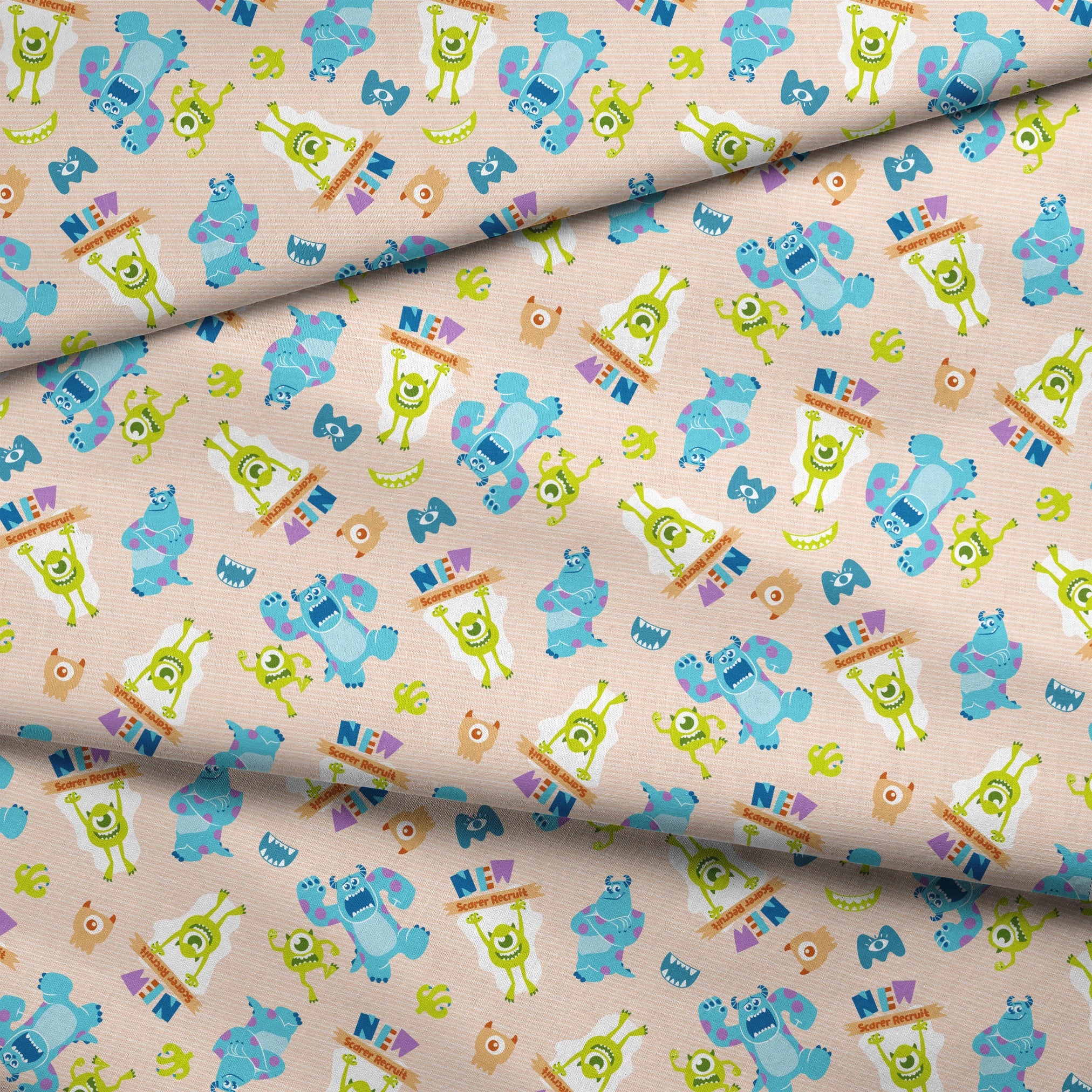 Colorful Monsters Inc pattern with Mike and Sully characters on peach background with scattered letters fabric fold mockup