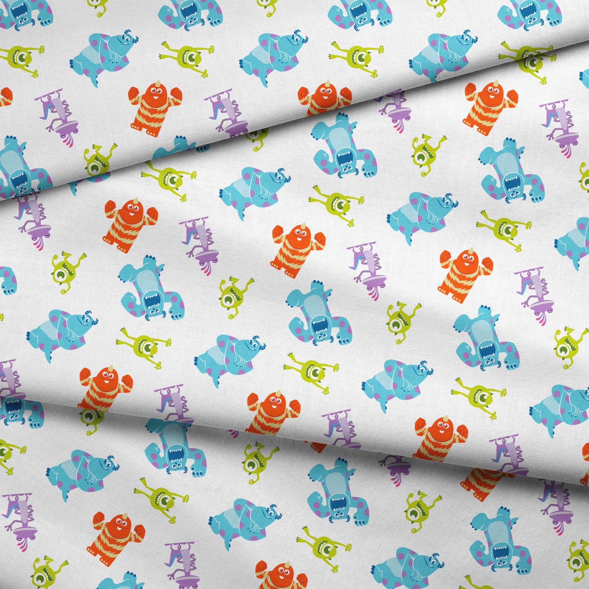 Cartoon monsters pattern with colorful characters - blue, green, purple and orange creatures on white background fabric fold mockup
