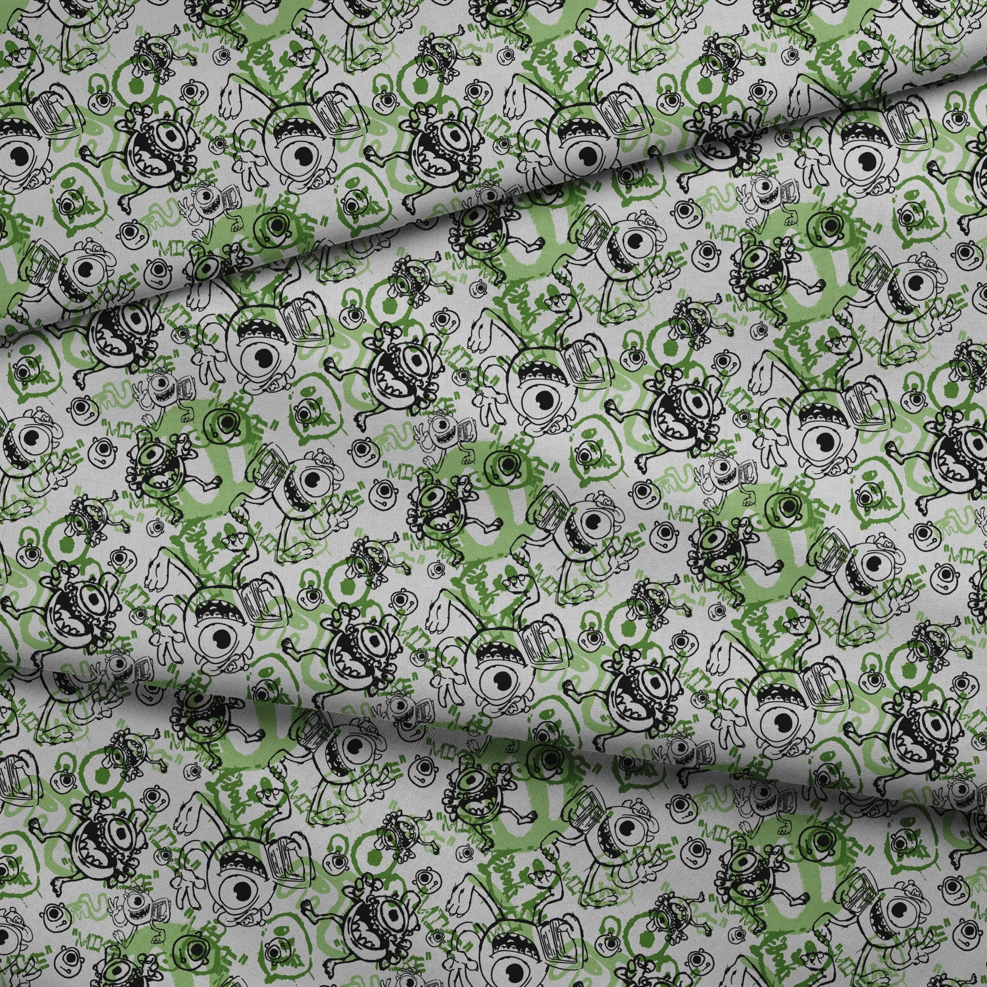Cartoon monsters doodle pattern in black and green on white background with large eyes and silly expressions fabric fold mockup