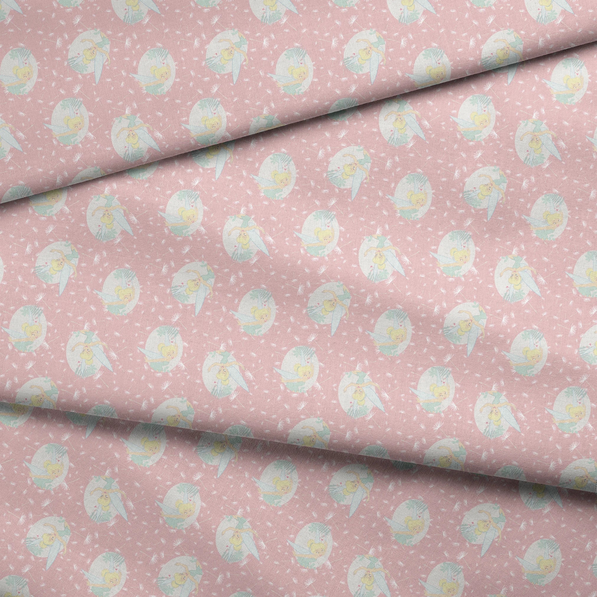 Pink background with dandelion seed pattern featuring Tinker Bell in mint green circles, whimsical Disney design fabric fold mockup