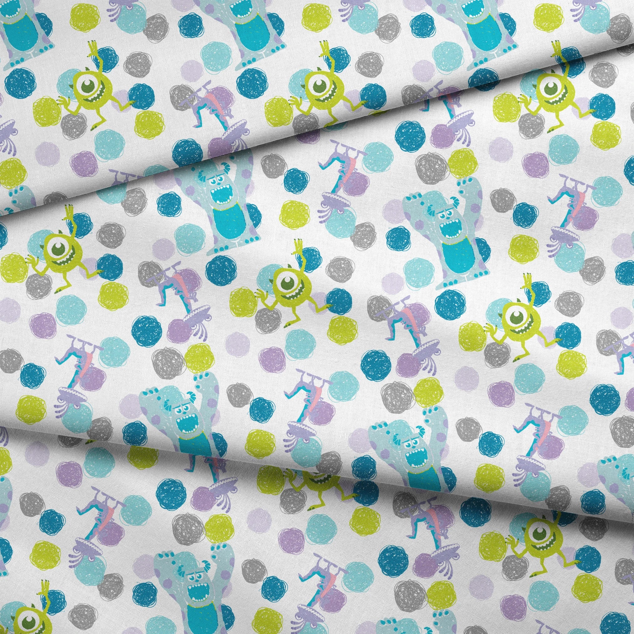 Colorful pattern featuring cartoon monsters with polka dots in blue, green, and purple on white background fabric fold mockup