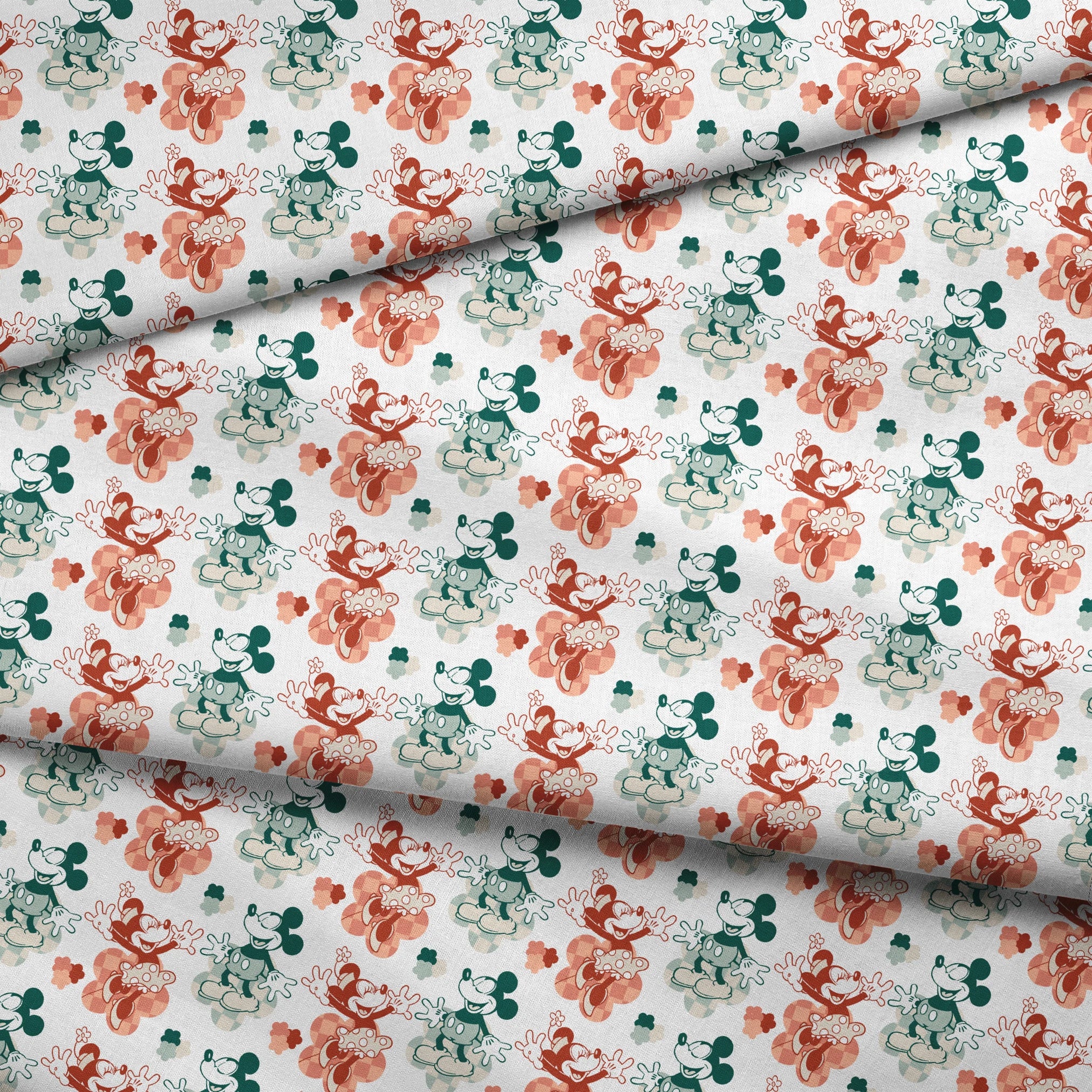 Repeating pattern of vintage-style cartoon characters in green and red-orange tones on white background fabric fold mockup