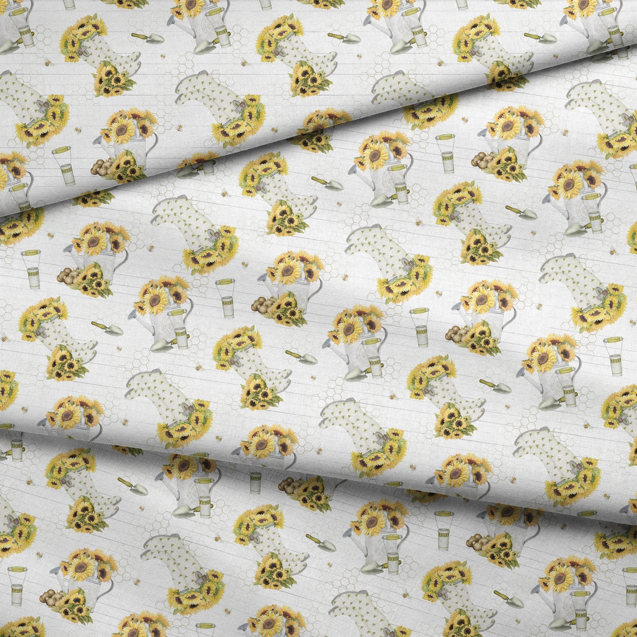 Sunflower-filled watering cans with bees, trowels, and garden tools on a white shiplap and honeycomb background. Designed by Nicole Tamarin. fabric fold mockup