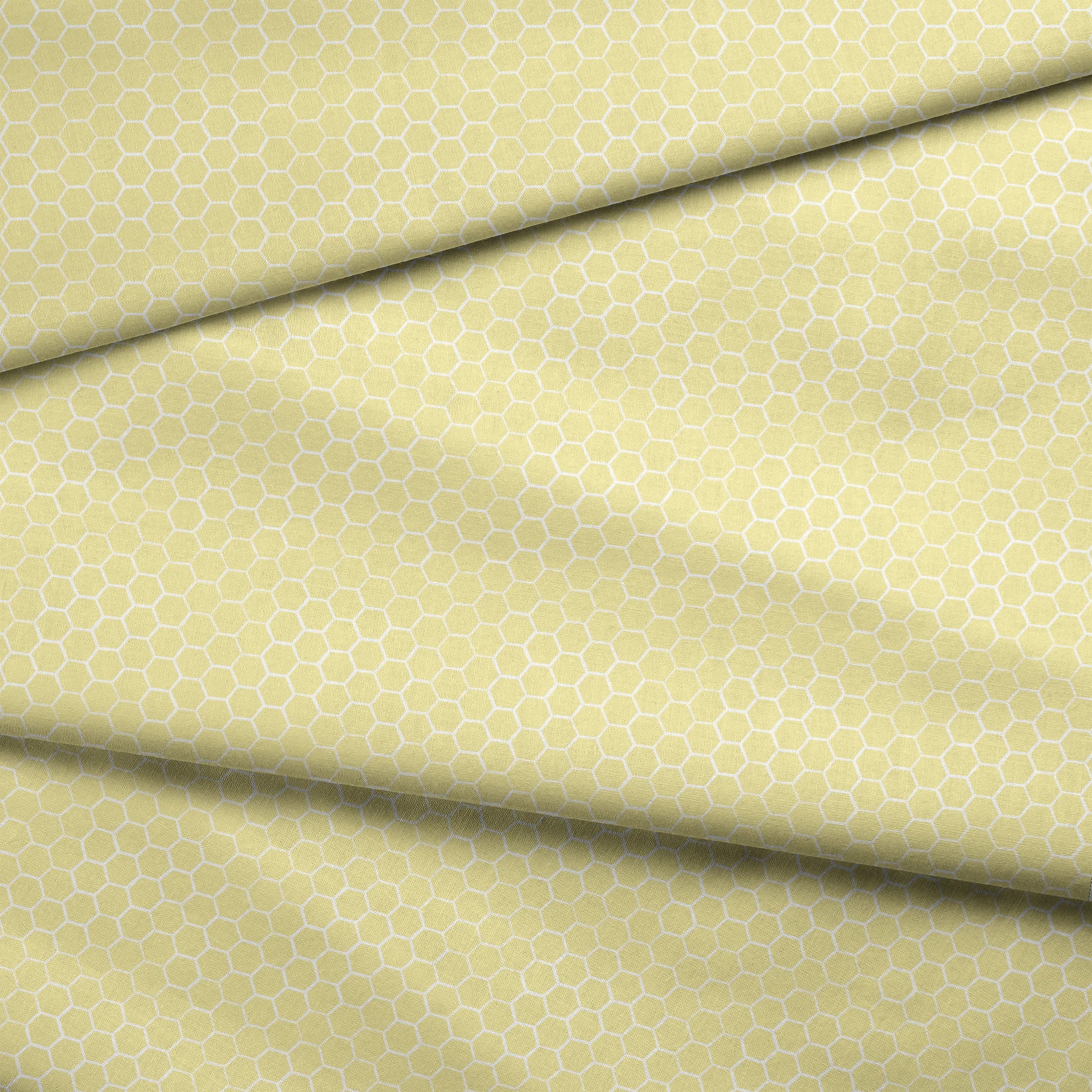 Yellow and white honeycomb pattern fabric designed by Nicole Tamarin with a soft geometric style perfect for bright, cheerful projects. fabric fold mockup