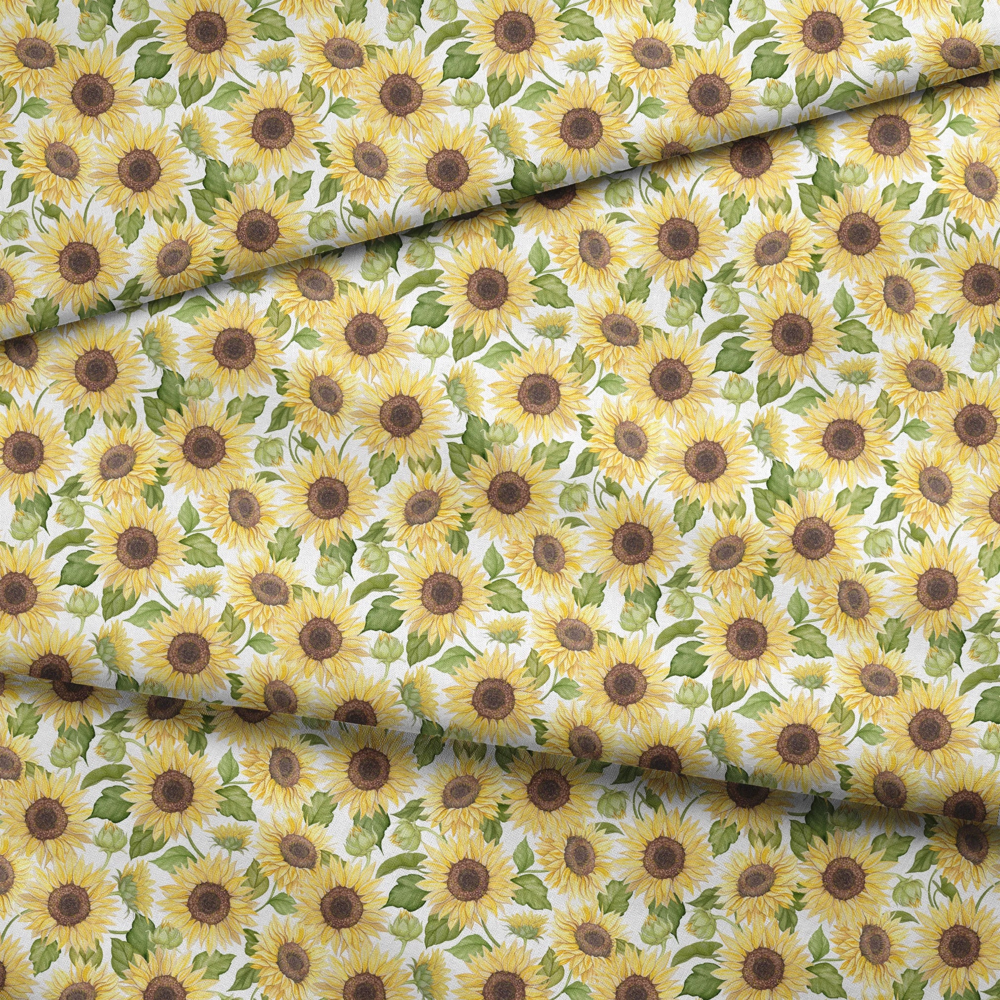 Watercolor-style packed sunflower pattern with yellow blooms and green leaves on a white background, designed by Nicole Tamarin. fabric fold mockup