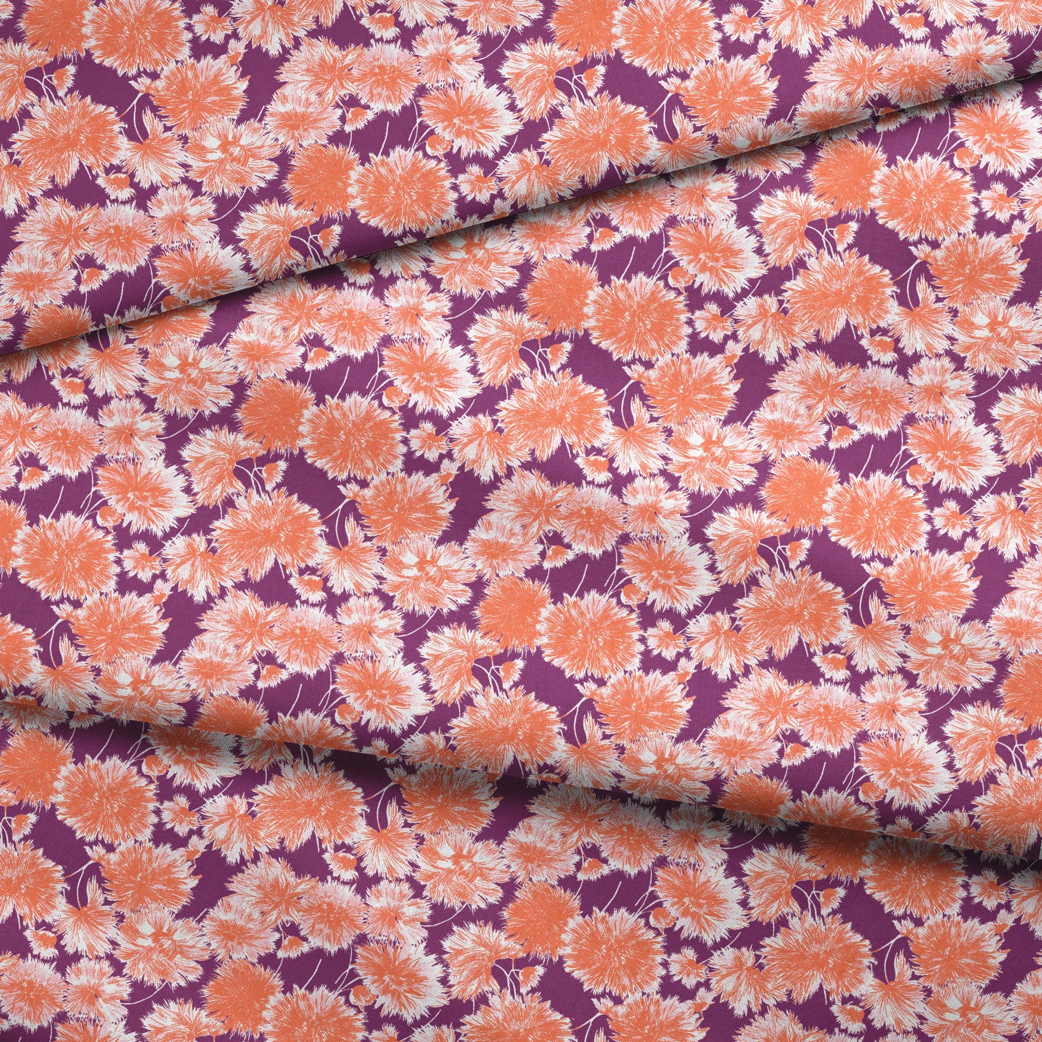 Vibrant floral pattern with orange and white chrysanthemum-like blooms on deep purple background fabric fold mockup