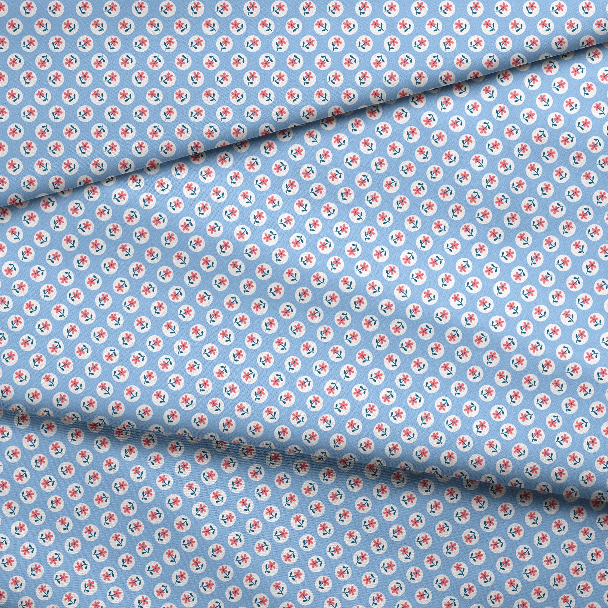 Pink flowers with blue-green stems in white circles on pale blue background, repeating pattern fabric fold mockup