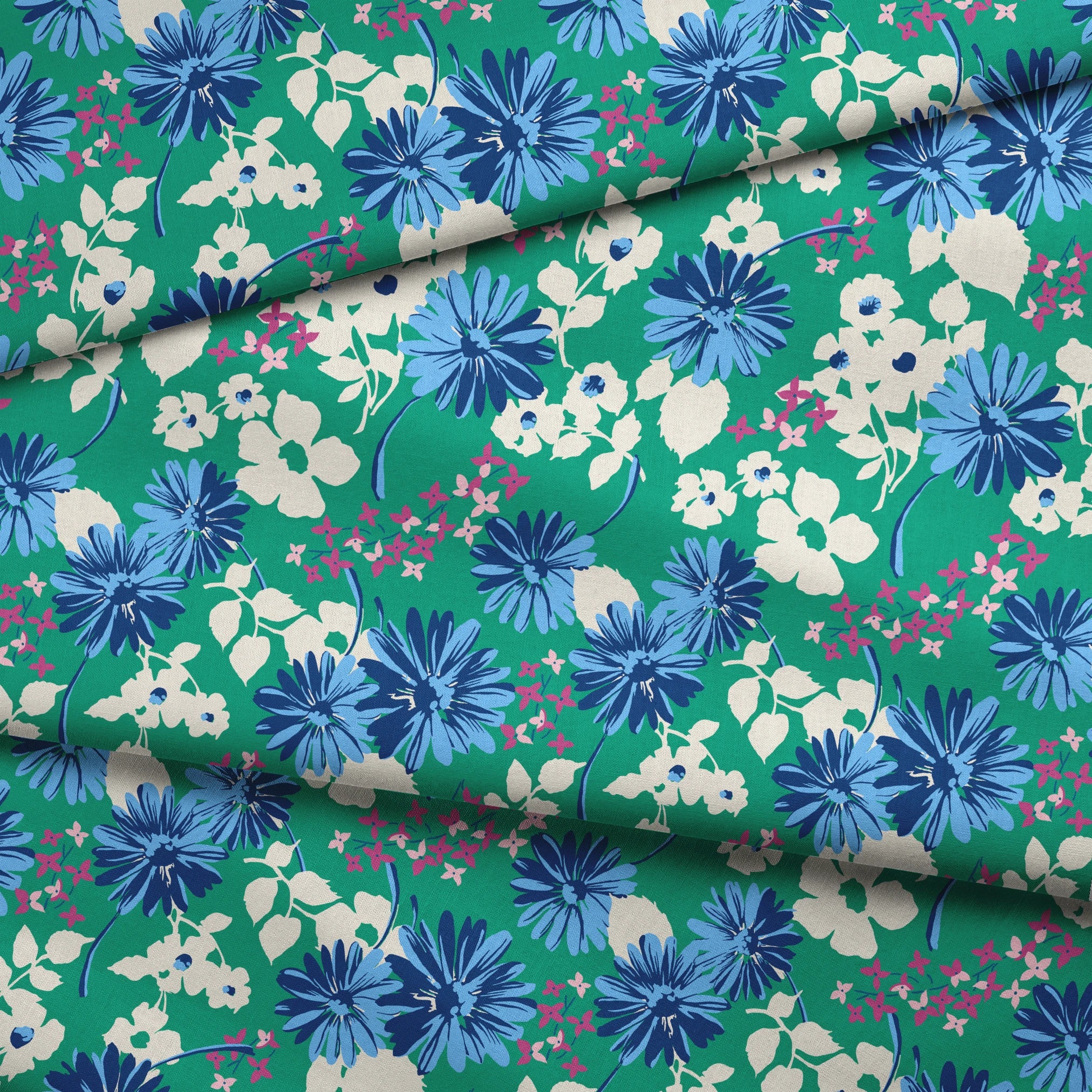 Vibrant floral pattern with blue spiky flowers and white blooms on a green background fabric fold mockup