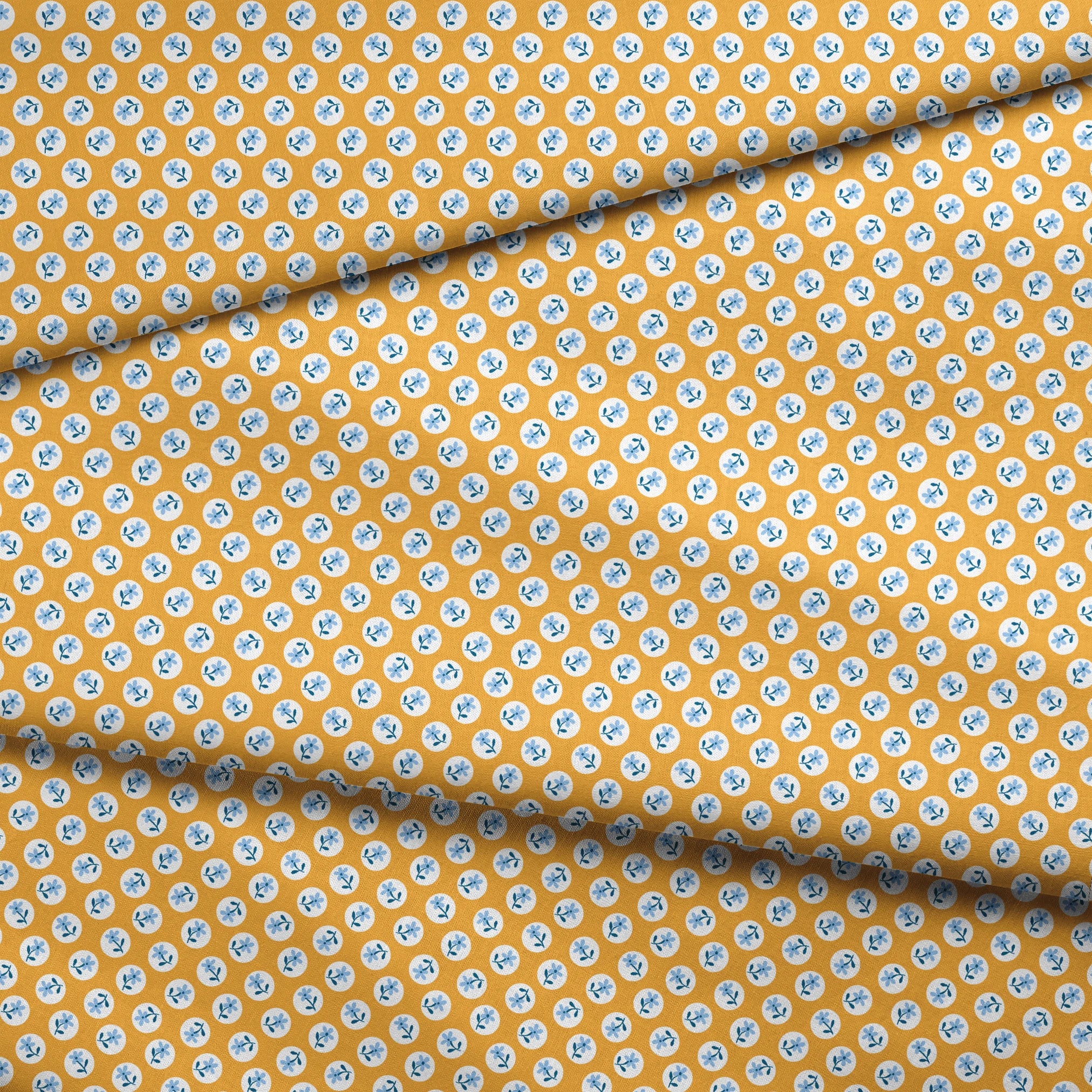 Light blue flowers with navy stems in white circles on a mustard yellow background fabric fold mockup