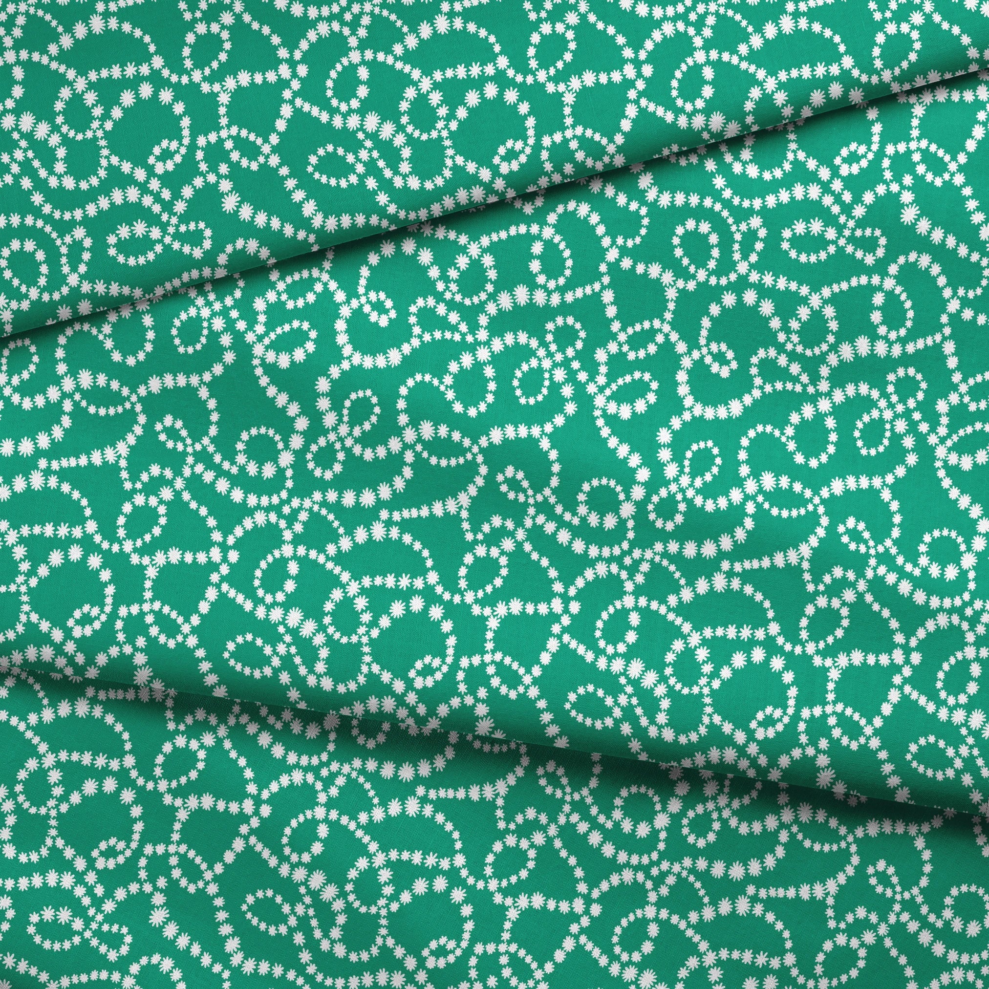 White dotted swirling patterns on green background forming abstract curving lines fabric fold mockup