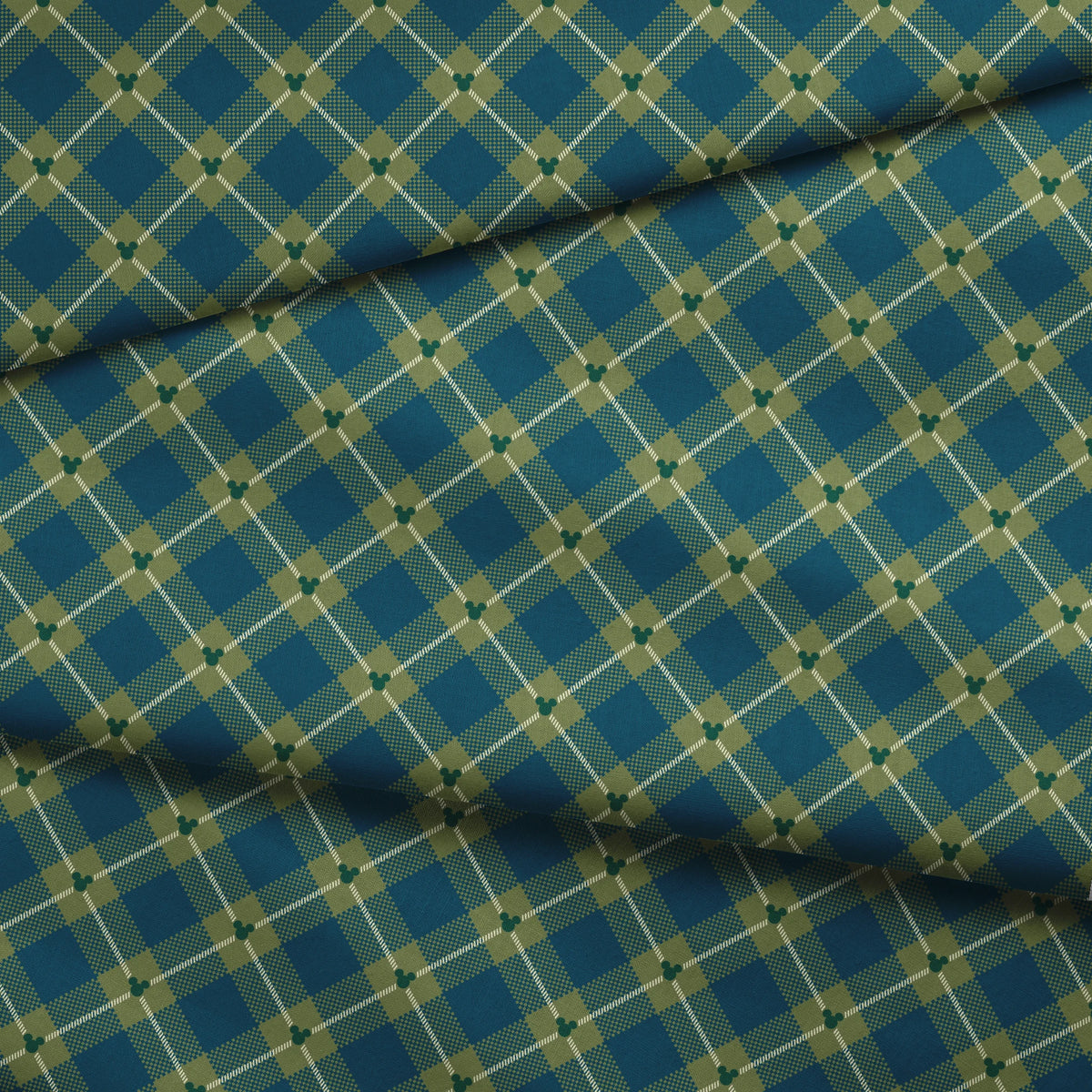 Geometric plaid pattern with teal and olive green diamonds, white diagonal stripes and checkered textures fabric fold mockup