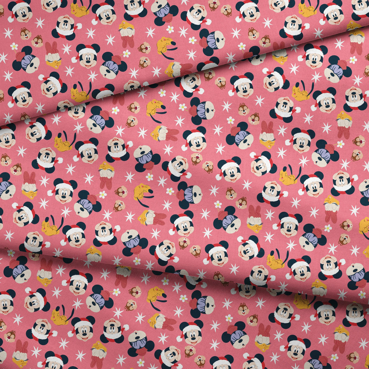 Mickey Mouse pattern with holiday elements on pink background, featuring white stars and gold accents fabric fold mockup