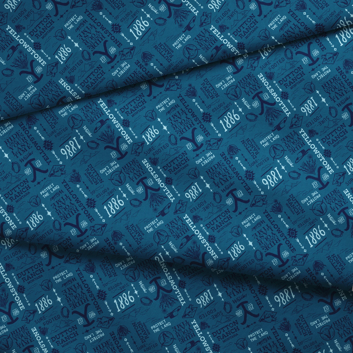 Paramount Yellowstone Verbiage Collage on Blue Fabric