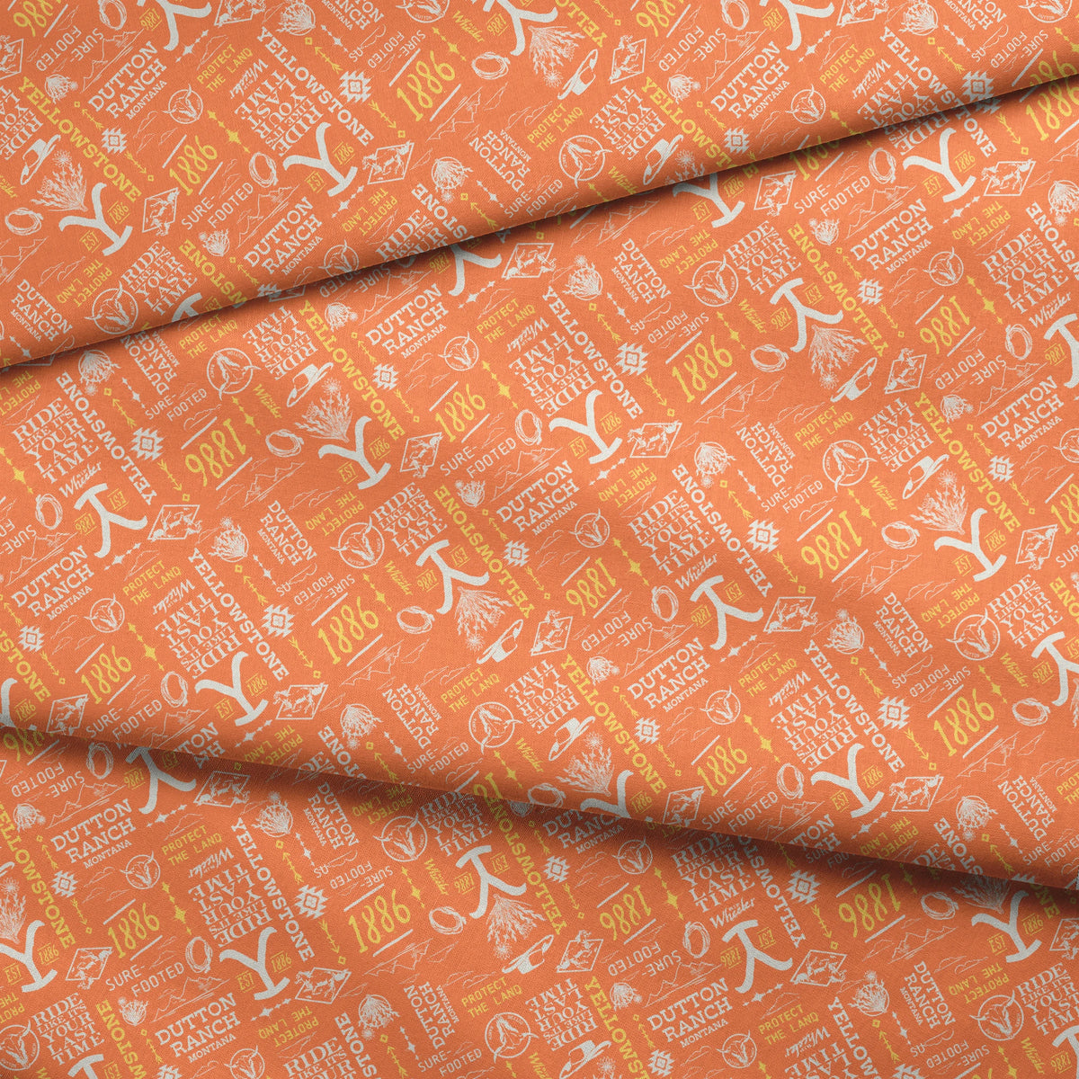 Paramount Yellowstone Verbiage Collage on Orange Fabric