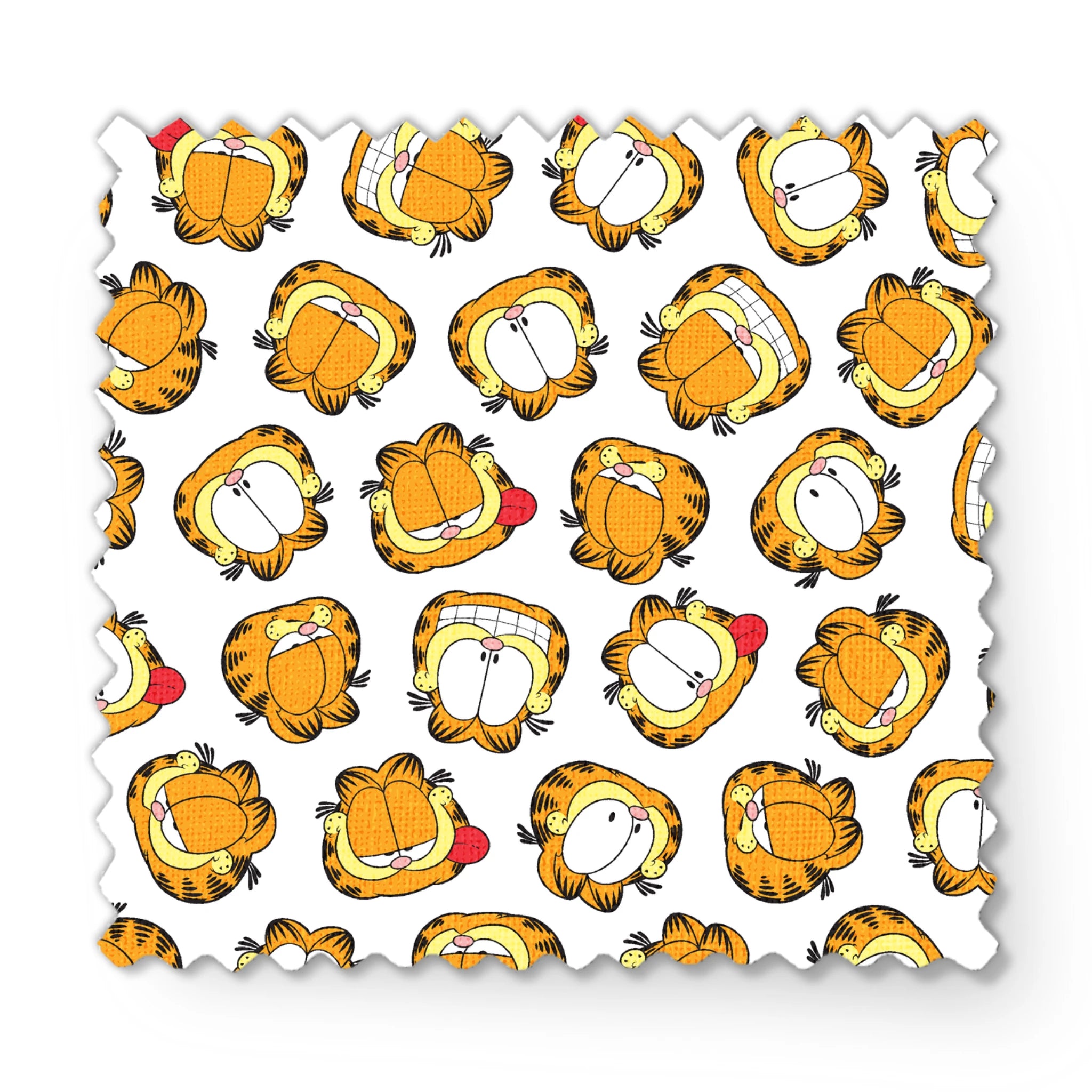 Pattern of cartoon cat faces with orange and yellow coloring against white background fabric swatch mockup