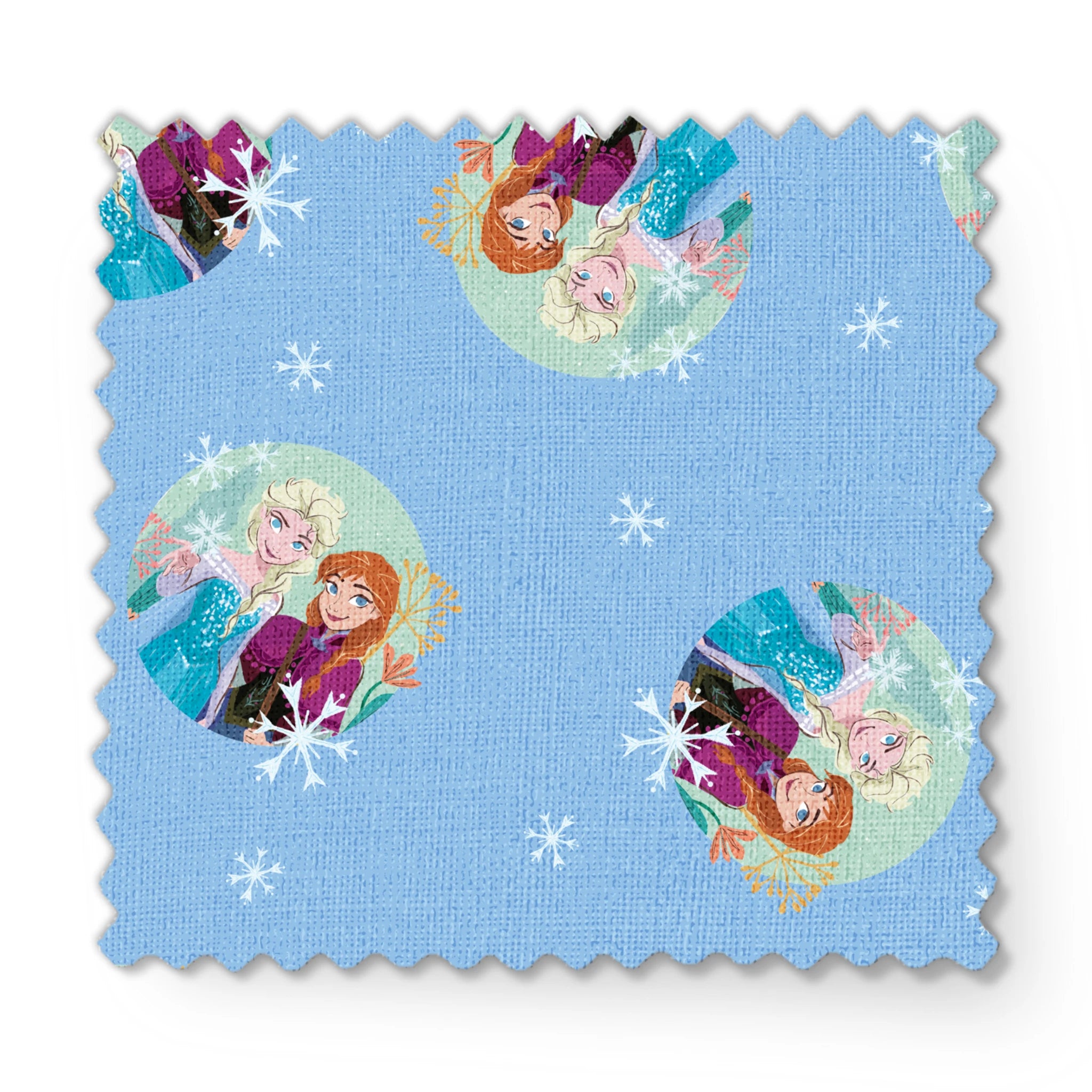 Light blue background with repeating circular motifs of "Frozen" characters and snowflakes in a decorative pattern fabric swatch mockup