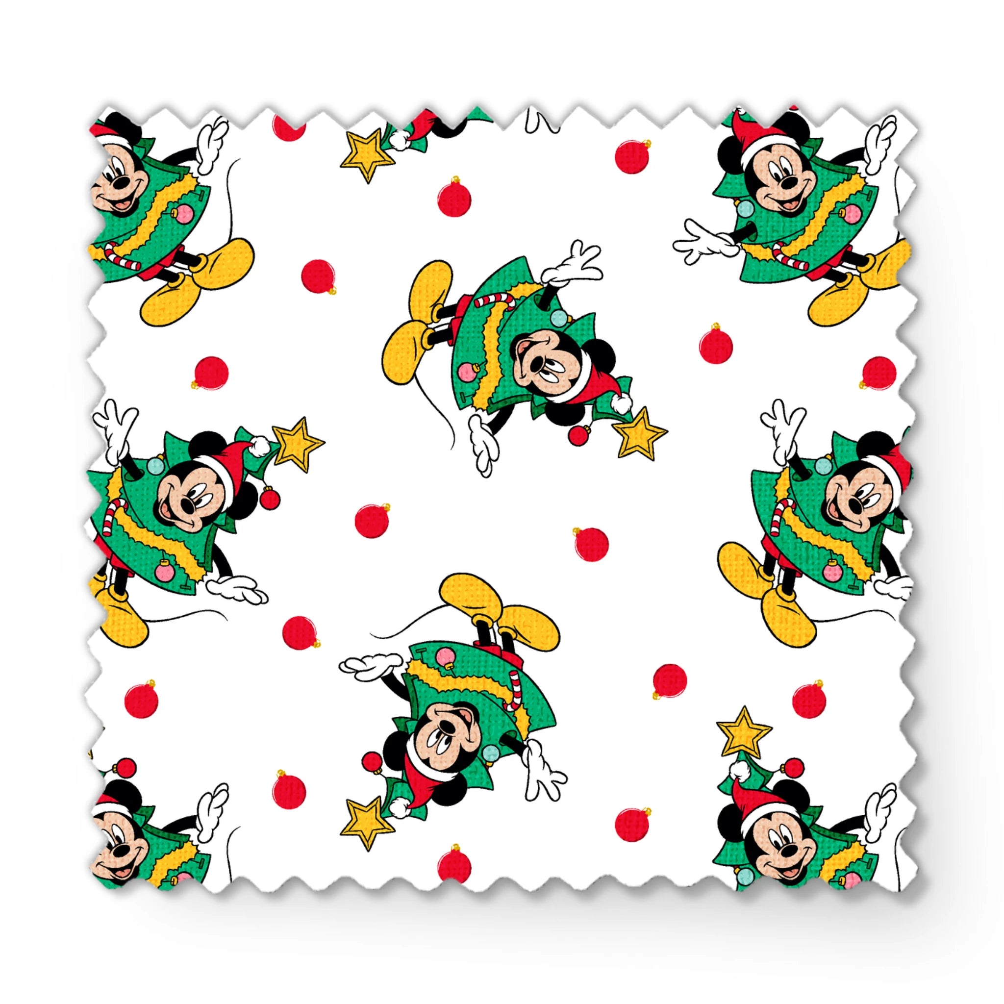 Mickey Mouse in a Christmas tree costume and stars on white background with red dots fabric swatch mockup