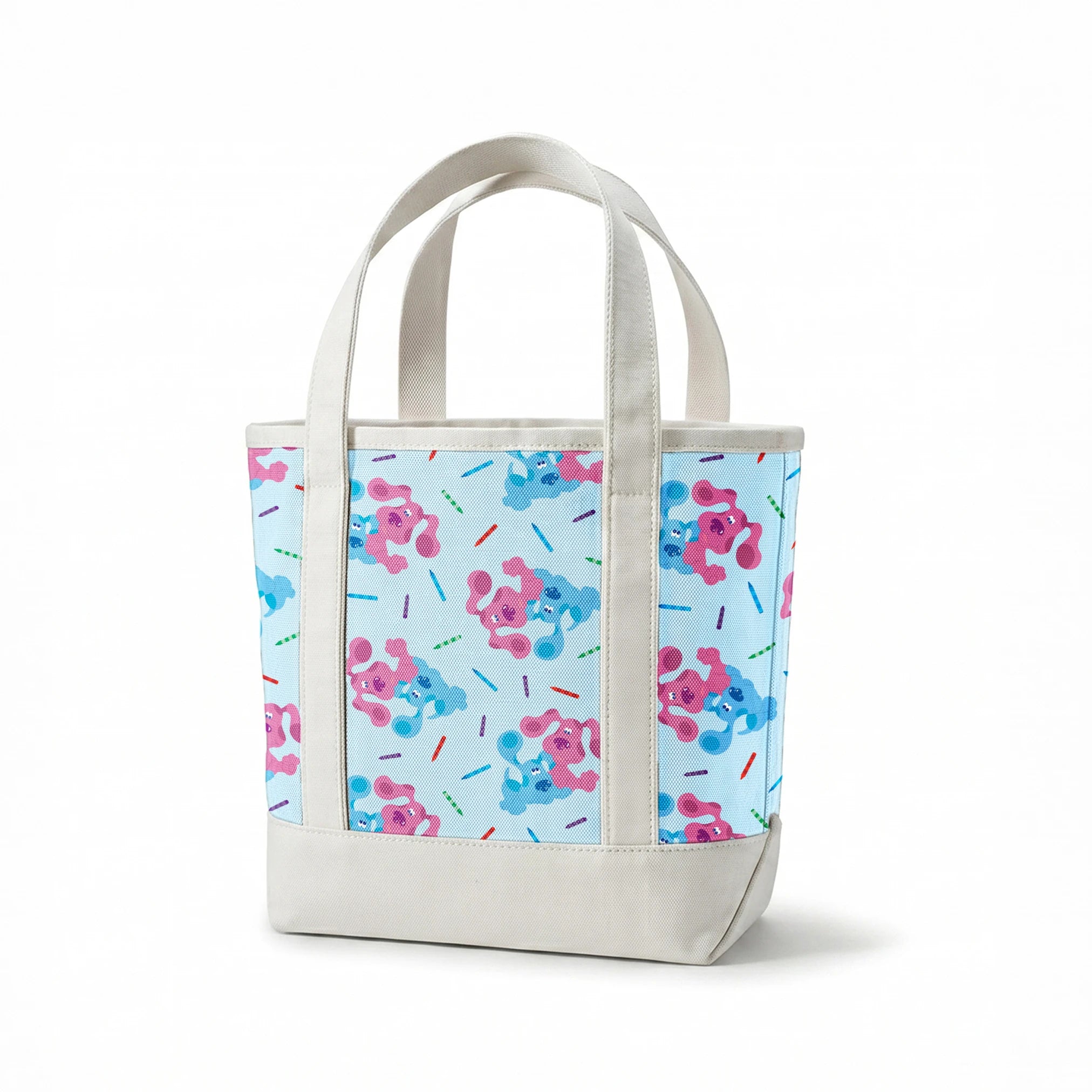 Playful pattern of cartoon blue and pink dogs with colorful stick accents on light blue background springs canvastote mockup
