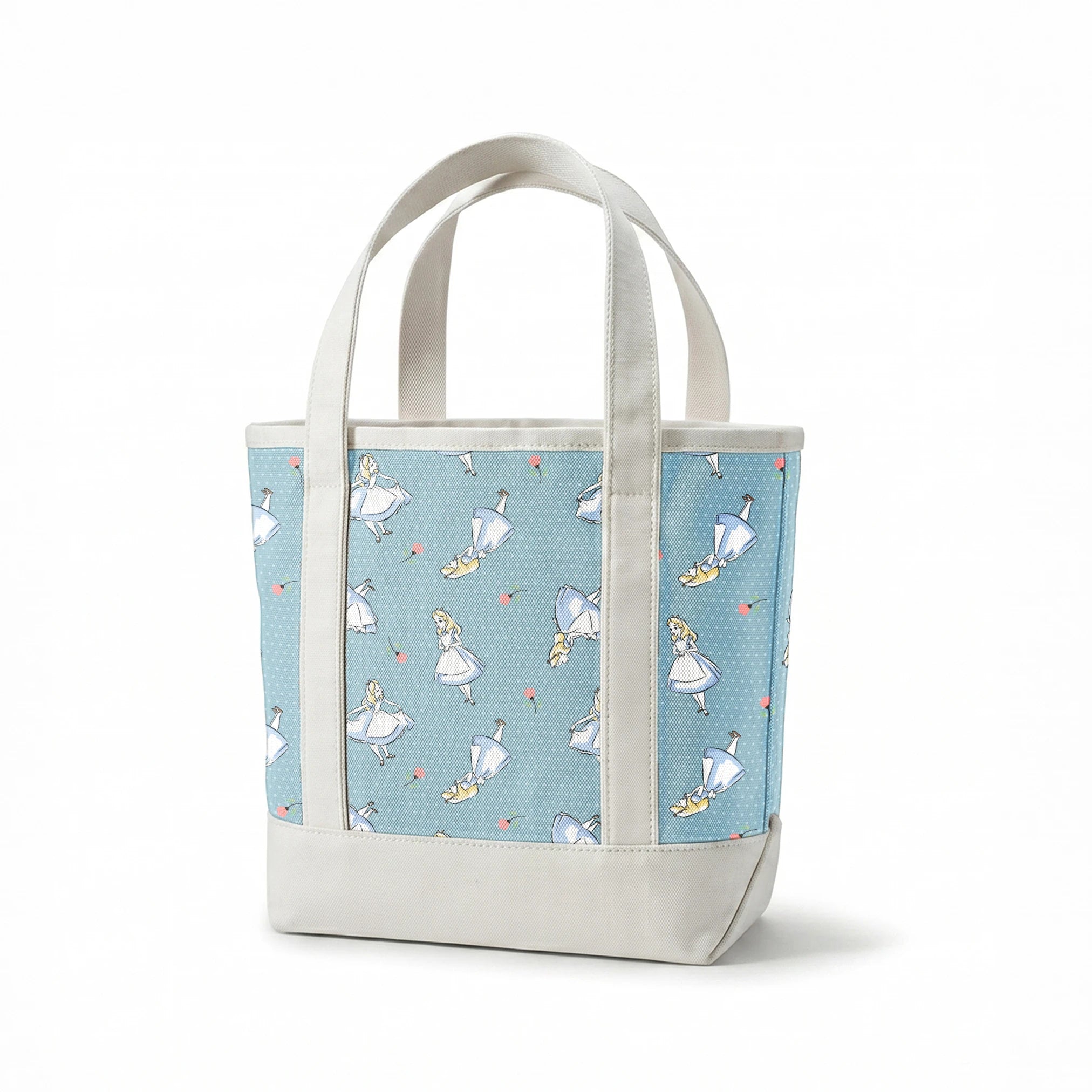 Blue polka dot pattern with illustrated characters in blue dresses and small pink flowers scattered throughout. springs canvastote mockup