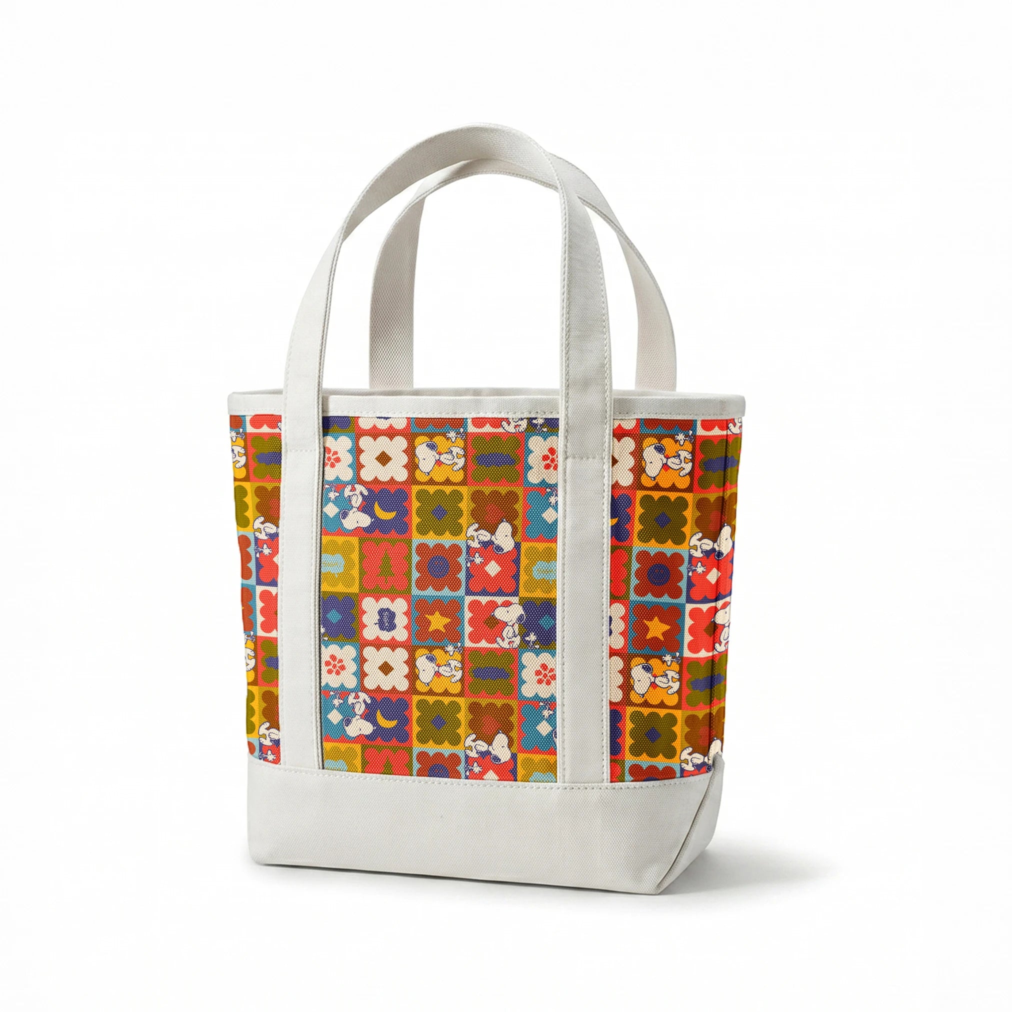Colorful patchwork pattern featuring Snoopy characters in various squares with flowers, geometric shapes, and decorative elements springs canvastote mockup