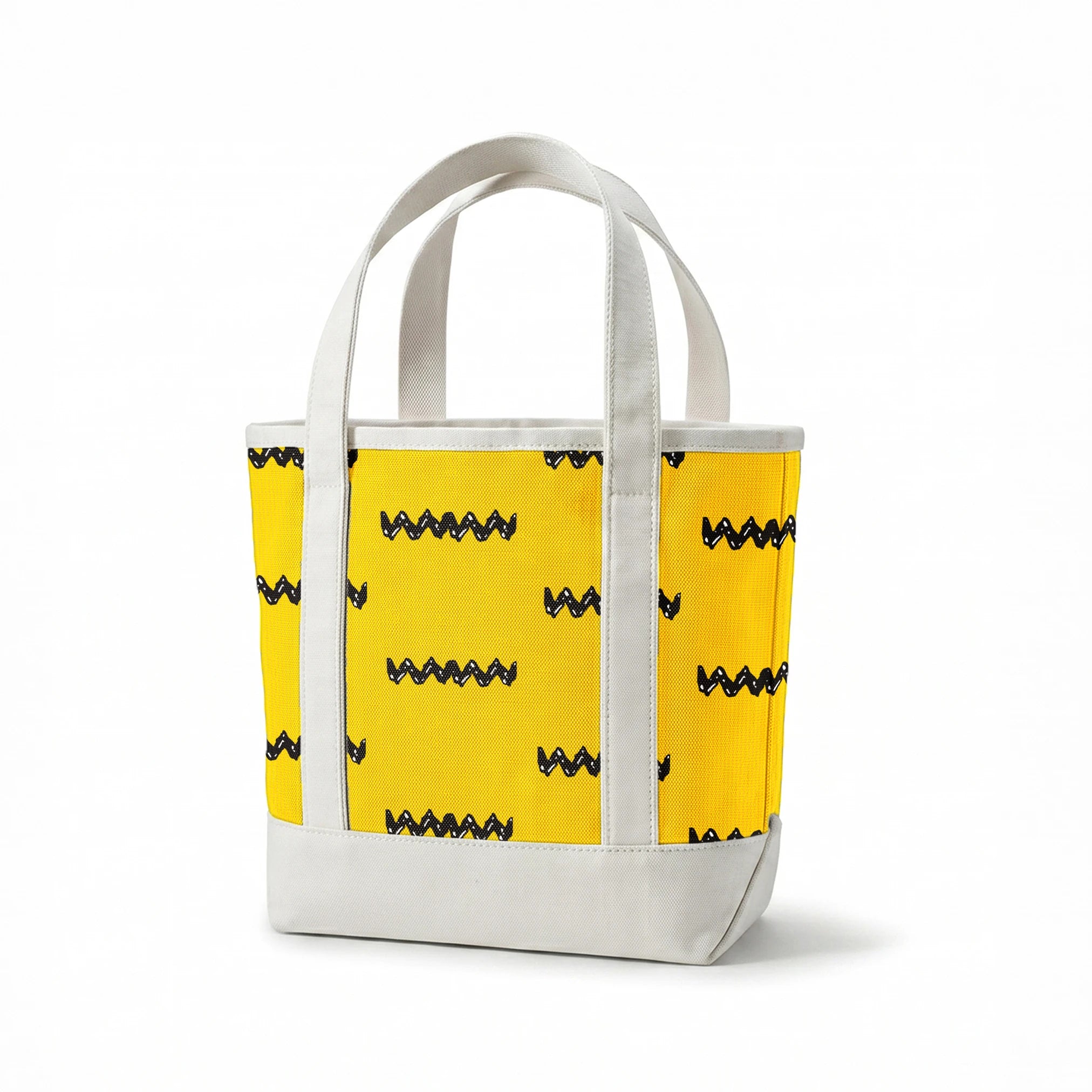 Black Charlie Brown zigzag patterns arranged in four rows against a bright yellow textured background springs canvastote mockup