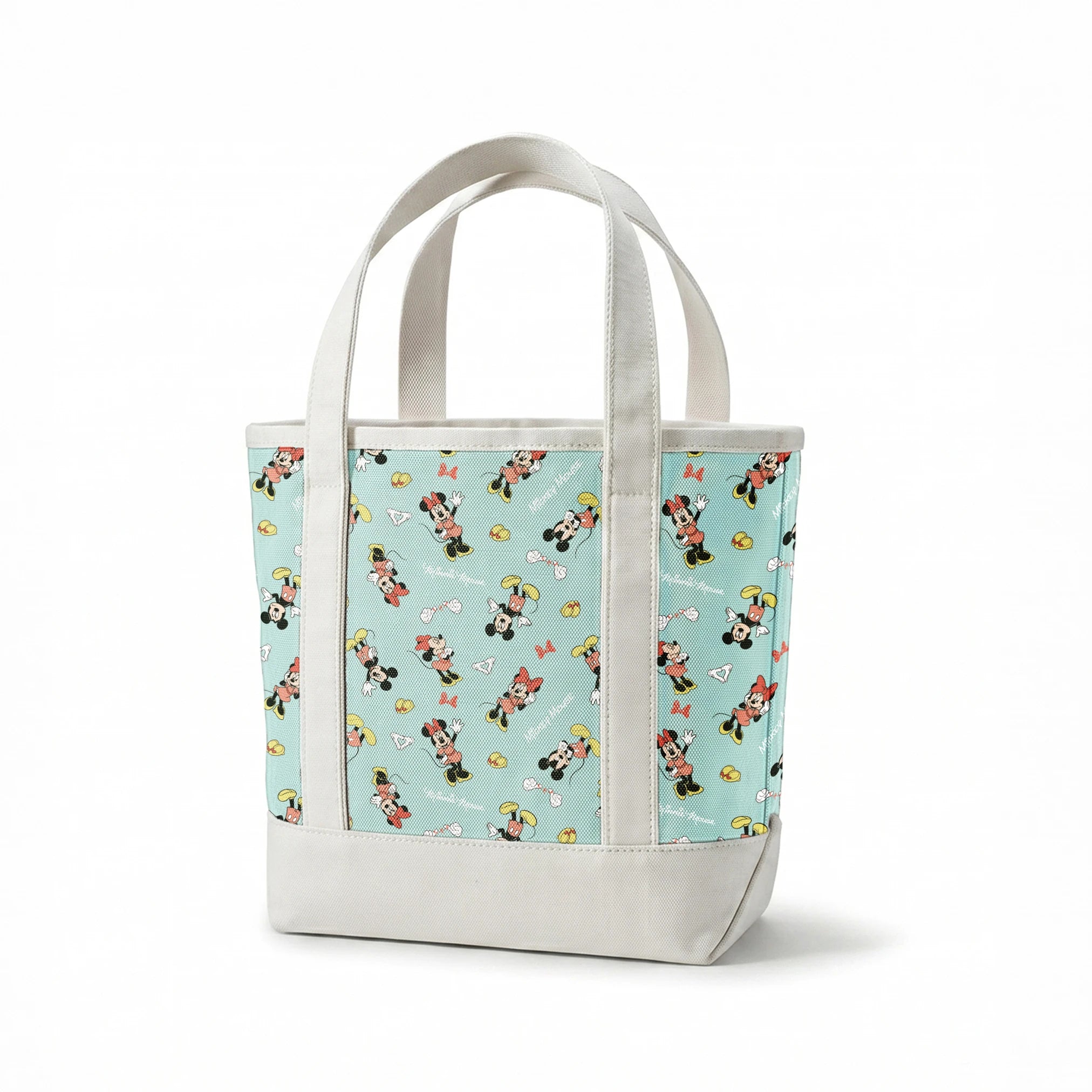 Mickey and Minnie Mouse pattern on light turquoise background with scattered characters, bows, and gloves springs canvastote mockup
