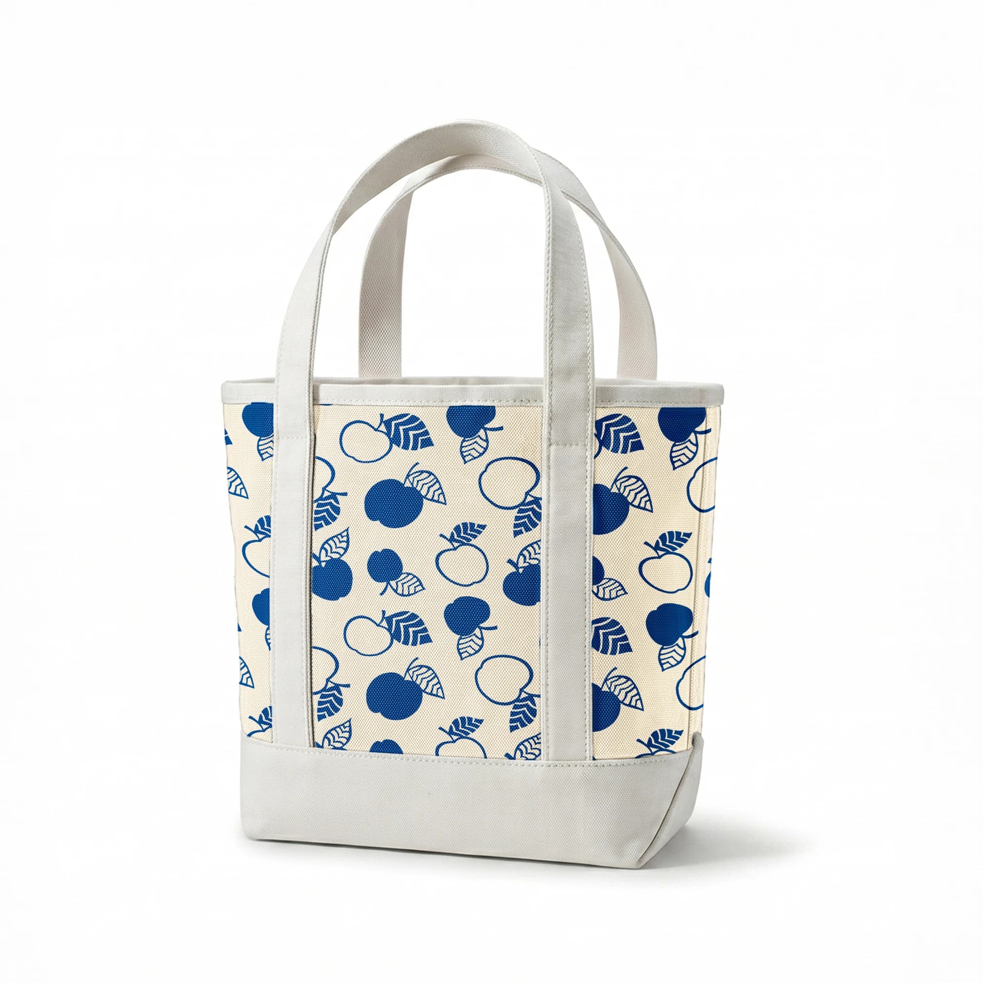 Blue apple illustrations and leaf outlines arranged in a scattered pattern on cream background. springs canvastote mockup