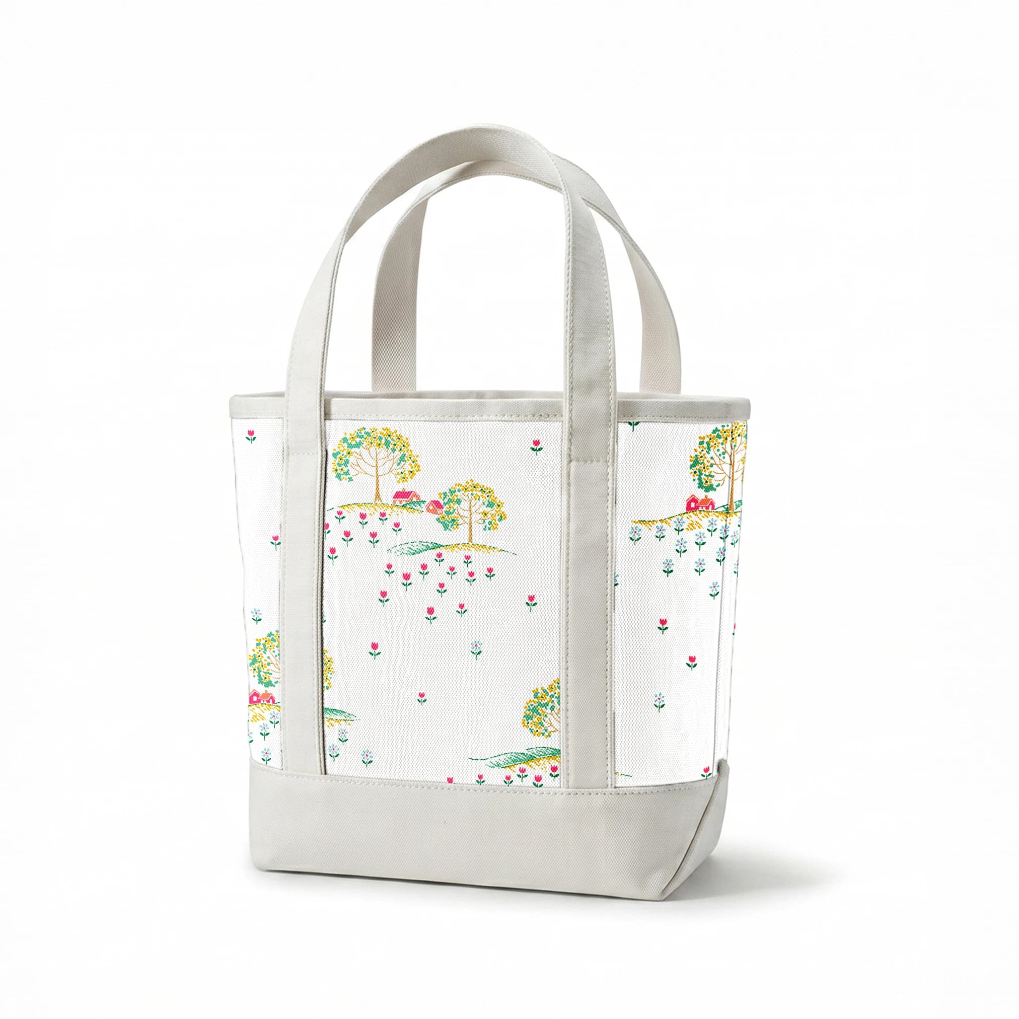 Whimsical pattern of colorful trees on small hills with scattered tiny flowers on a white background springs canvastote mockup