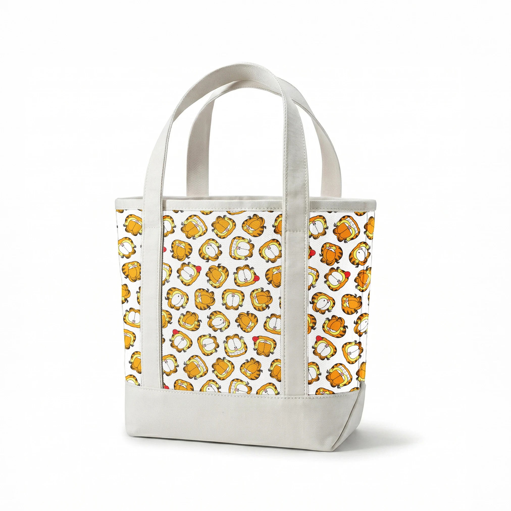 Pattern of cartoon cat faces with orange and yellow coloring against white background springs canvastote mockup