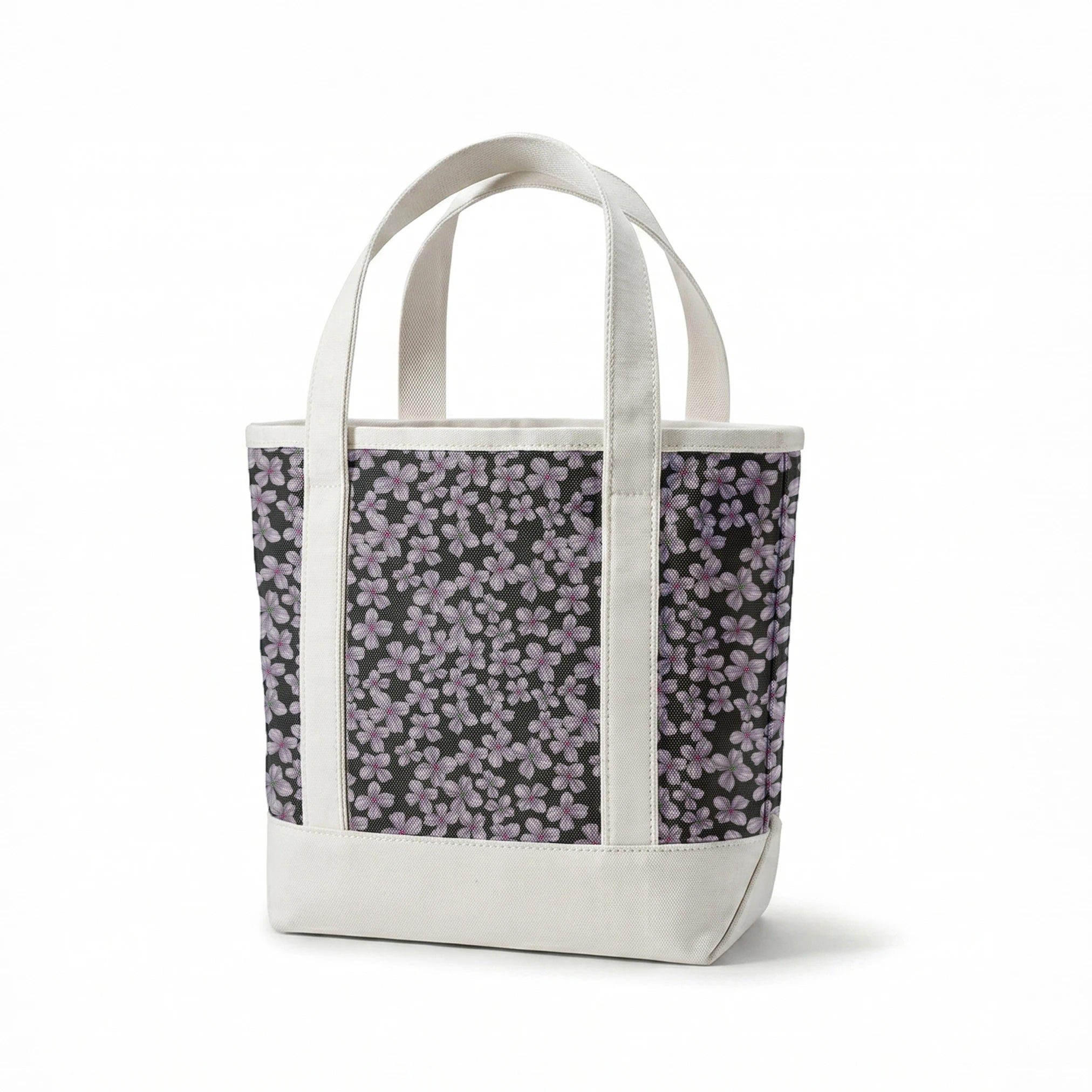 Hand-drawn purple flowers scattered on a charcoal background, designed by Nicole Tamarin. springs canvastote mockup