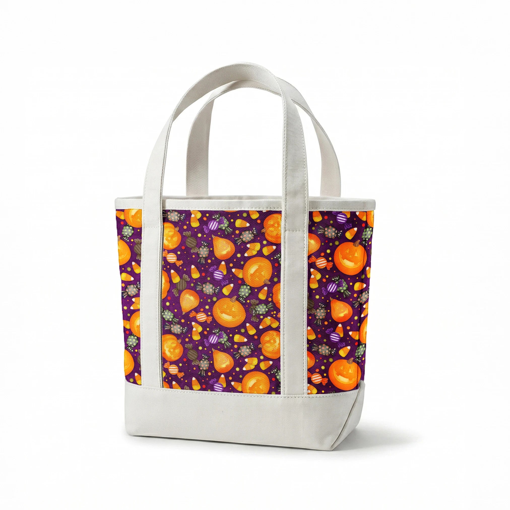 Playful Halloween fabric design by Nicole Tamarin featuring smiling jack-o’-lanterns, wrapped candies, and candy corn scattered across a purple background. springs canvastote mockup