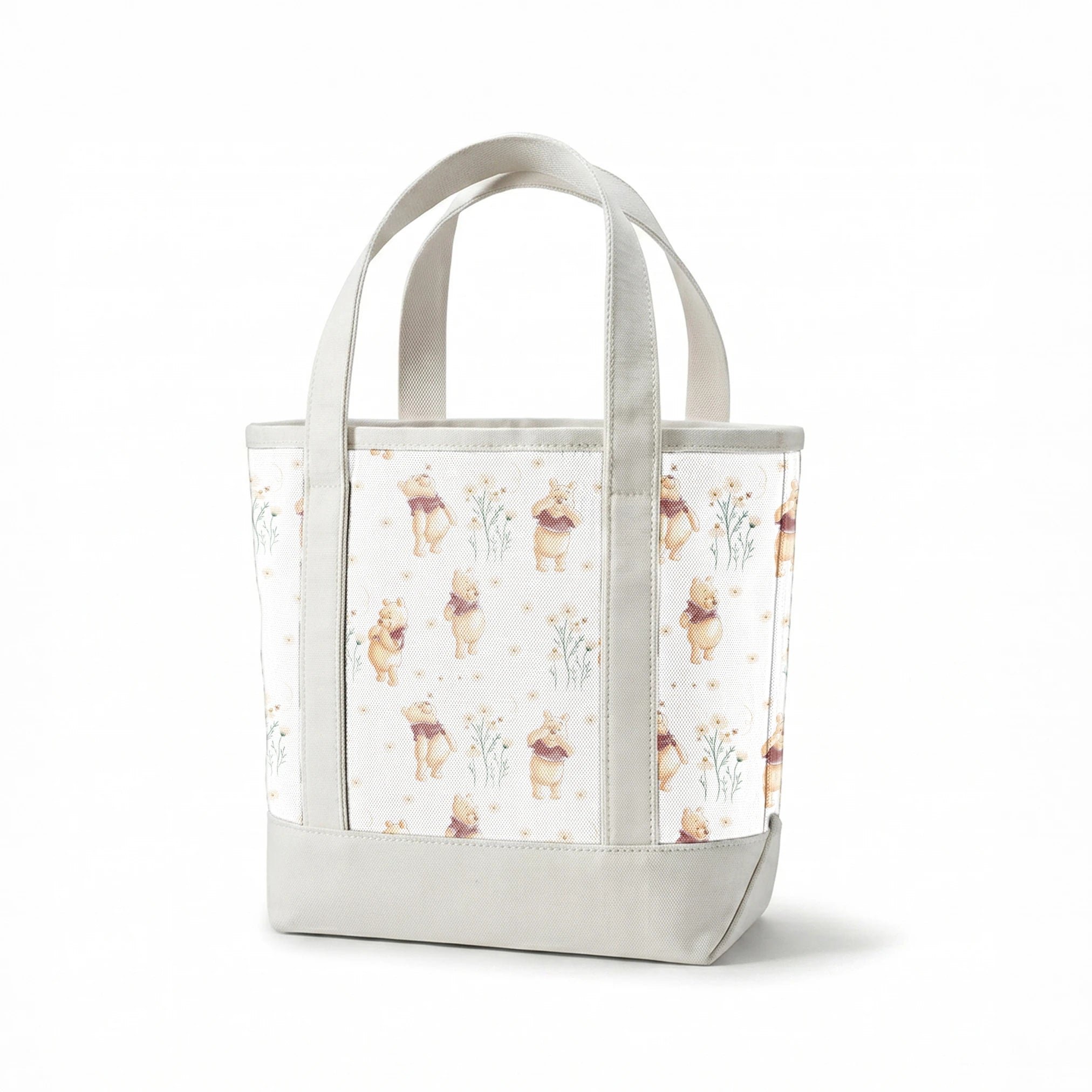 Winnie the Pooh pattern with cartoon bear in red shirt amid delicate white flowers springs canvastote mockup