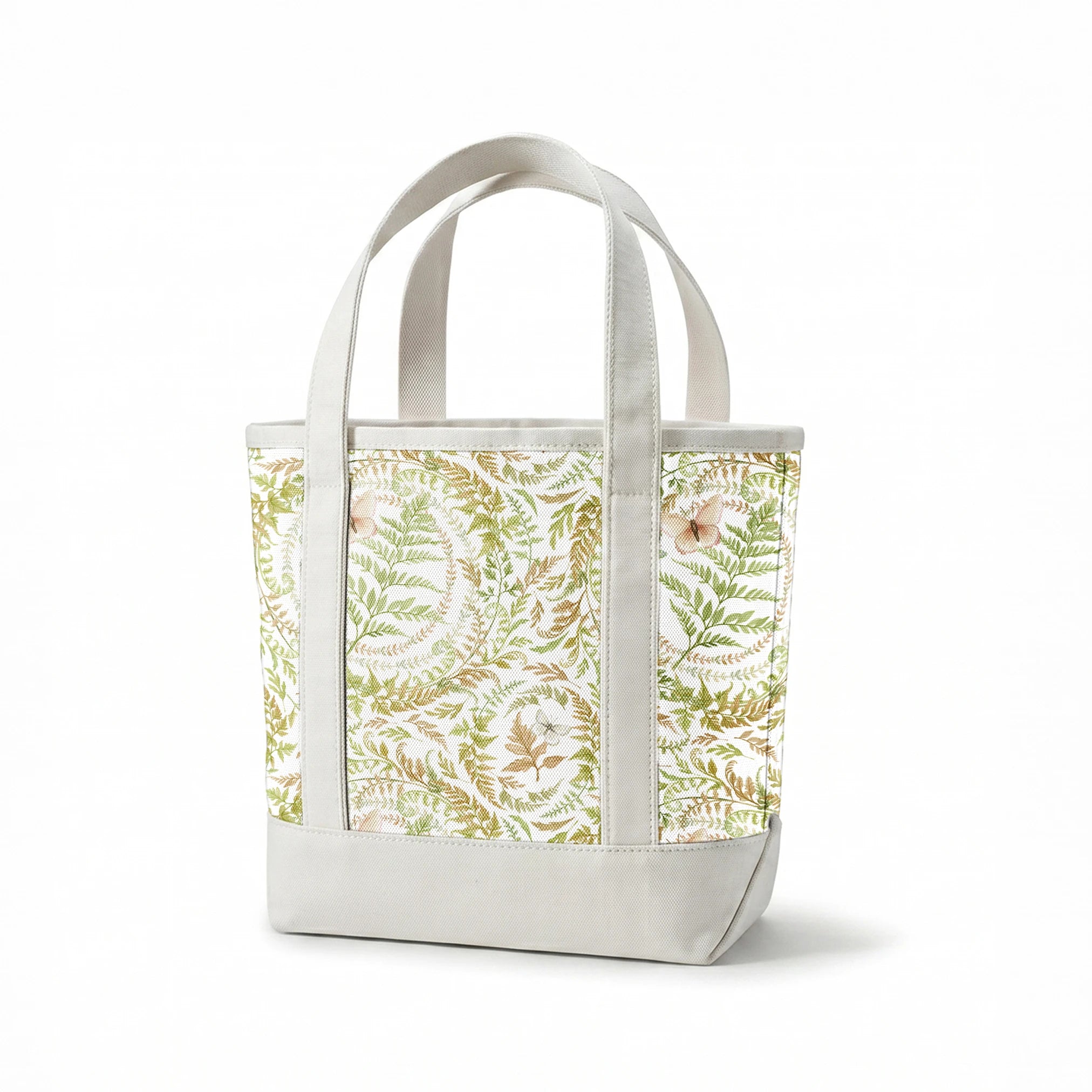 Circular botanical design featuring green ferns and blush butterflies on a white background in a Nicole Tamarin pattern. springs canvastote mockup
