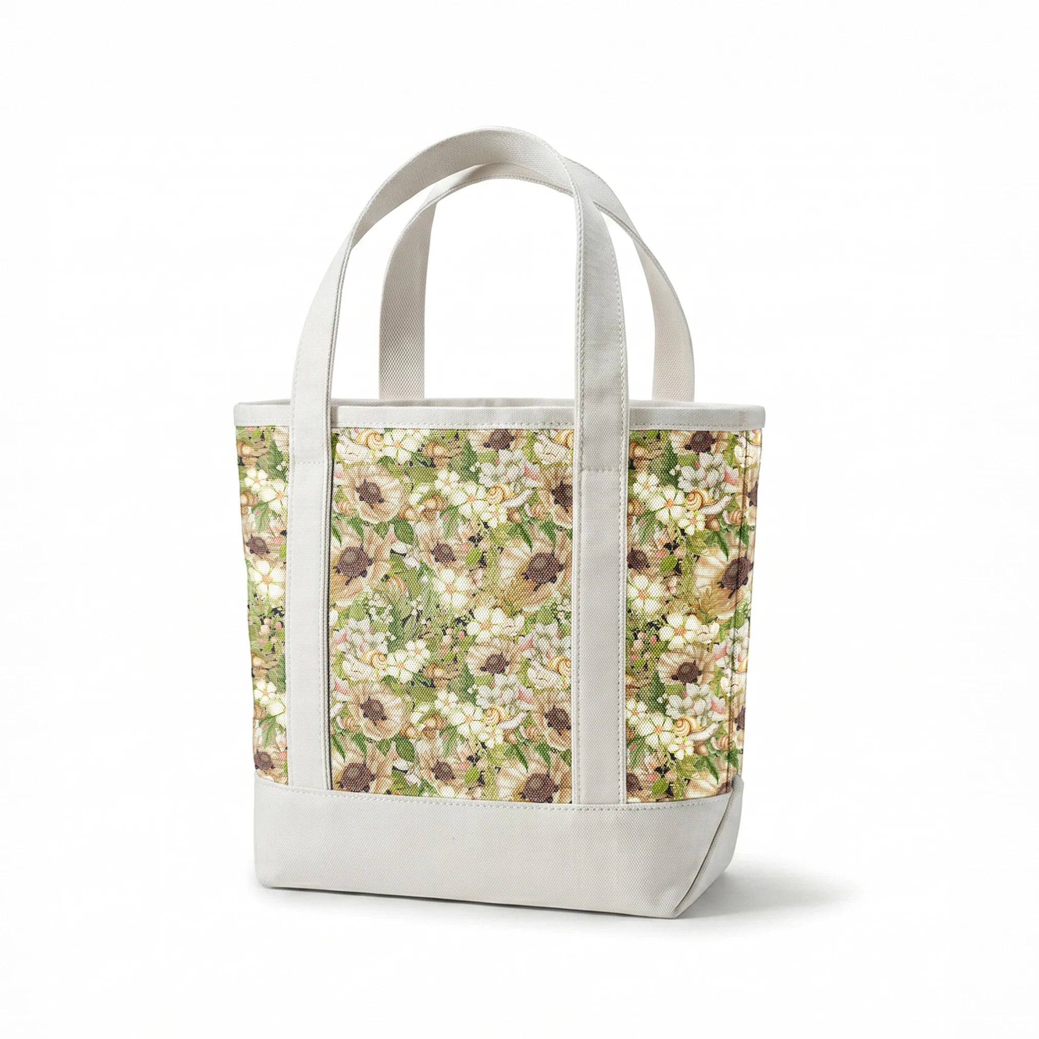 Botanical pattern by Nicole Tamarin featuring cream poppies, snails, acorns, and soft green leaves in an earthy woodland layout. springs canvastote mockup