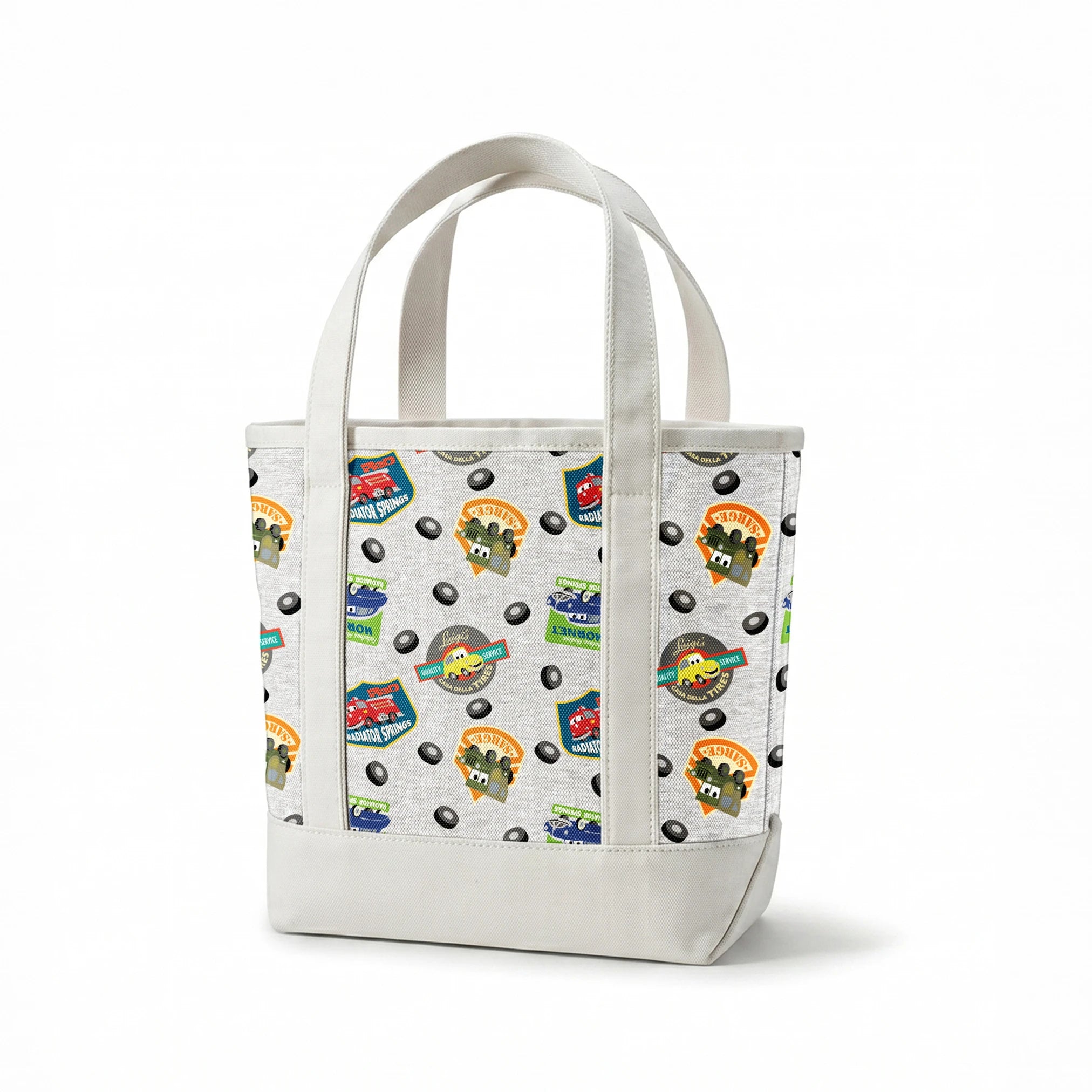 Cartoon vehicle characters on gray fabric with badges for Radiator Springs, Luigi's, and Sarge's springs canvastote mockup