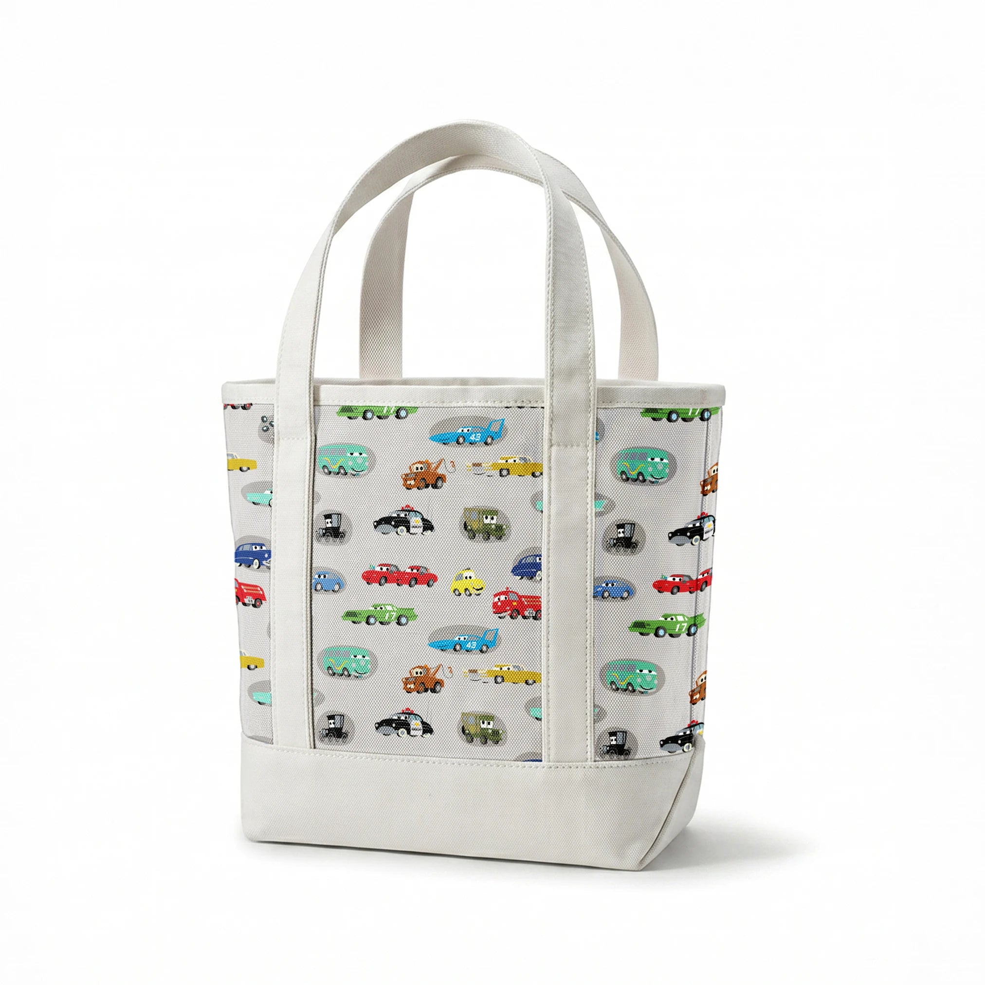 Various cartoon toy cars and vehicles in different colors (red, blue, green, yellow) displayed against a gray background with cute animated faces. springs canvastote mockup