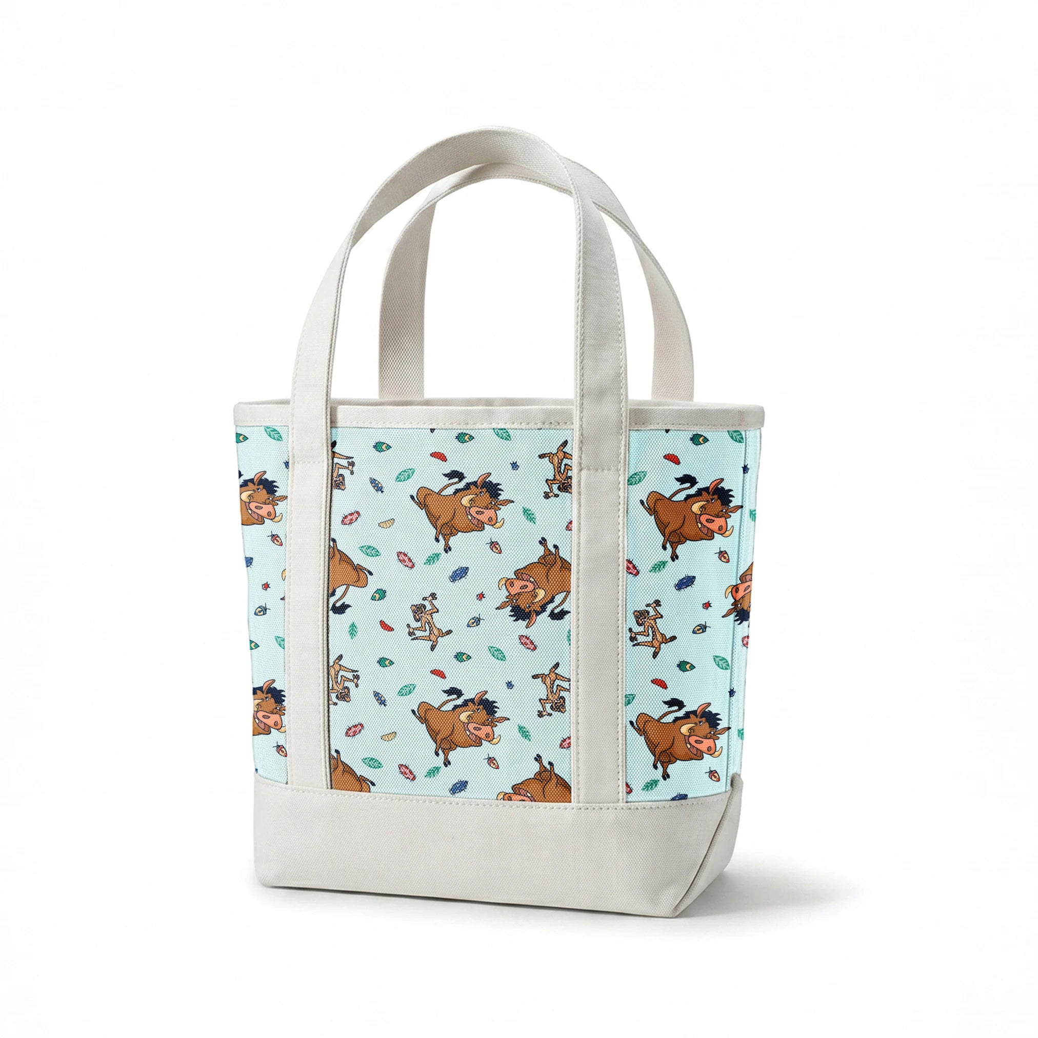 Lion King characters and colorful leaves scattered on light blue background in playful pattern springs canvastote mockup
