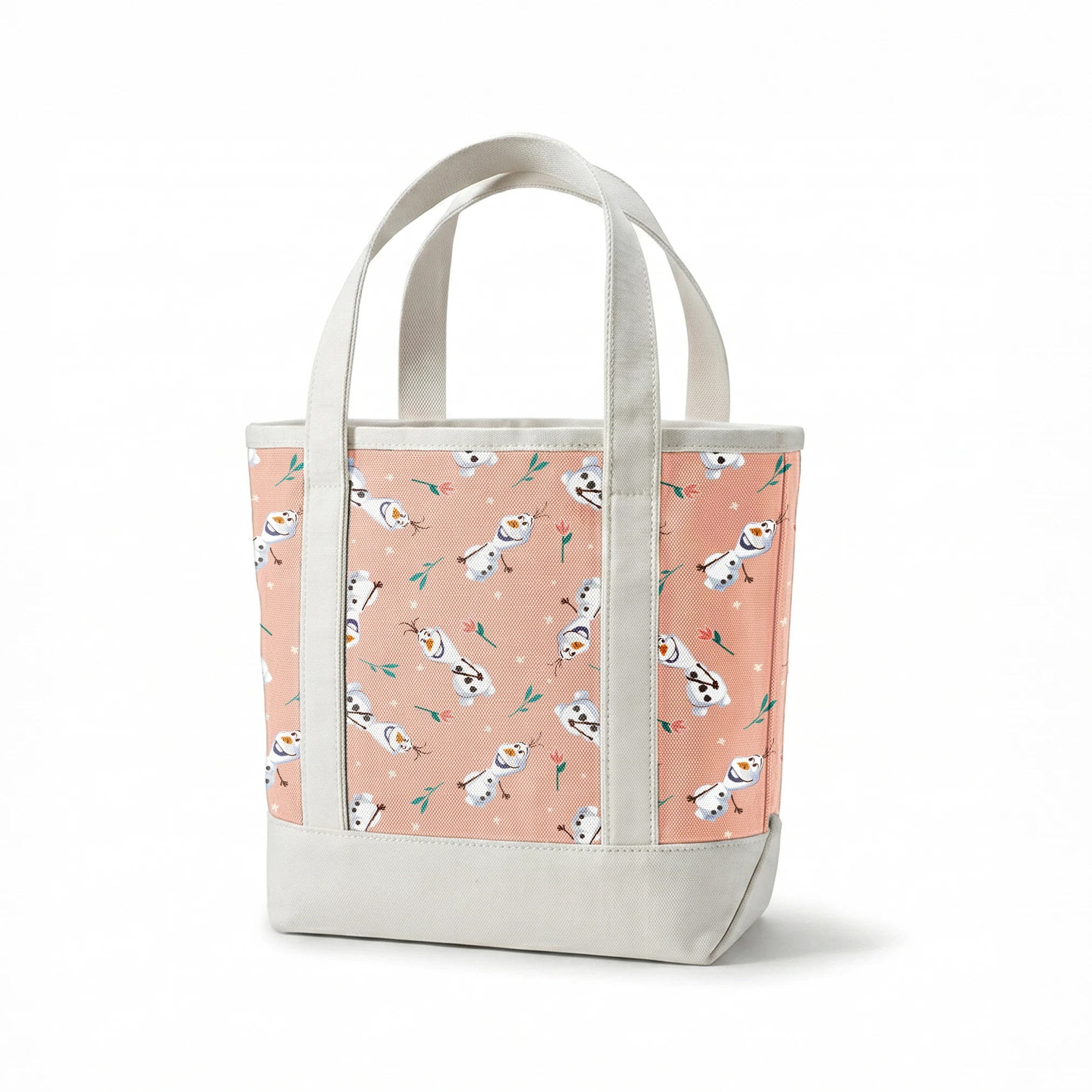 Playful pattern of Olaf scattered with green leaves on a peachy pink background springs canvastote mockup