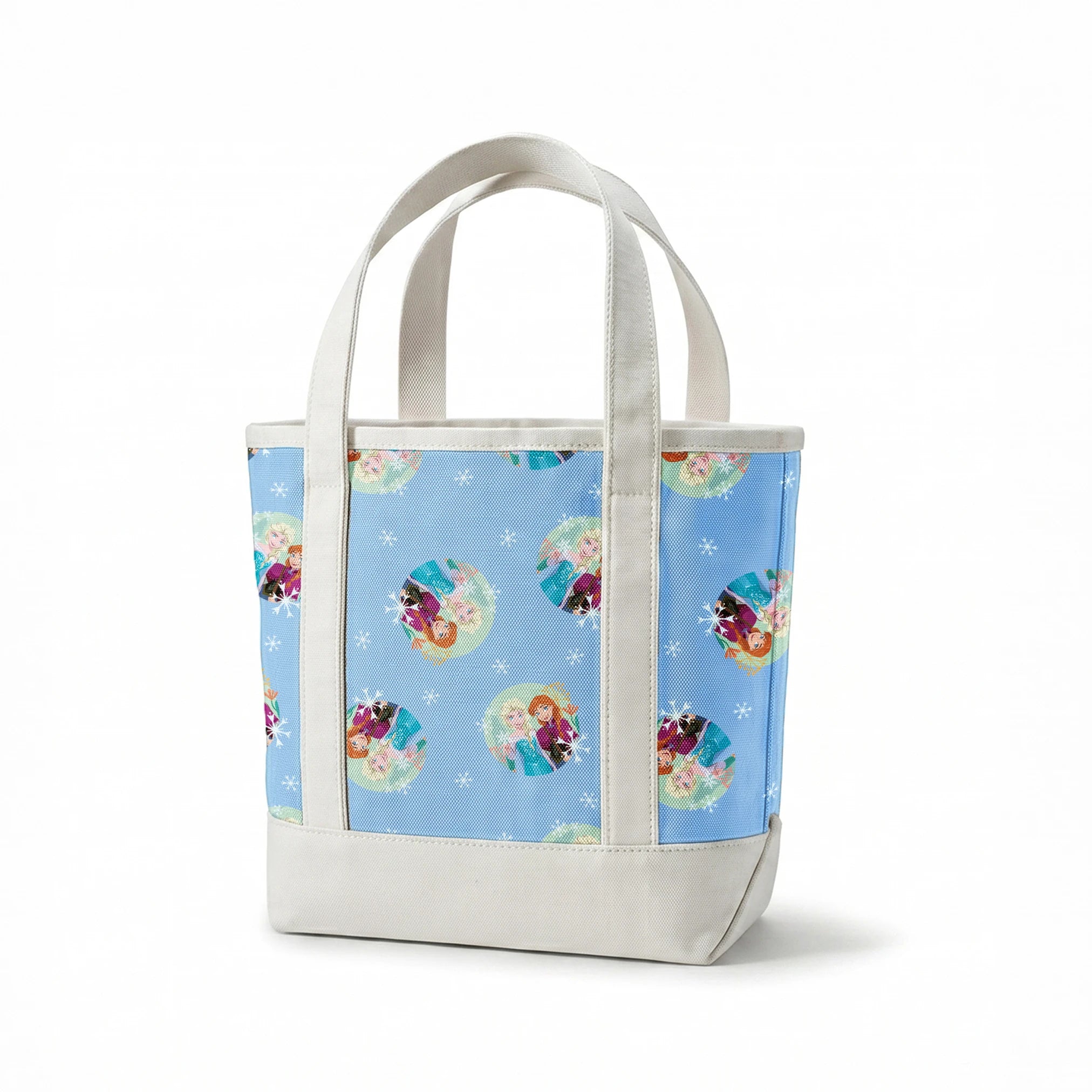 Light blue background with repeating circular motifs of "Frozen" characters and snowflakes in a decorative pattern springs canvastote mockup
