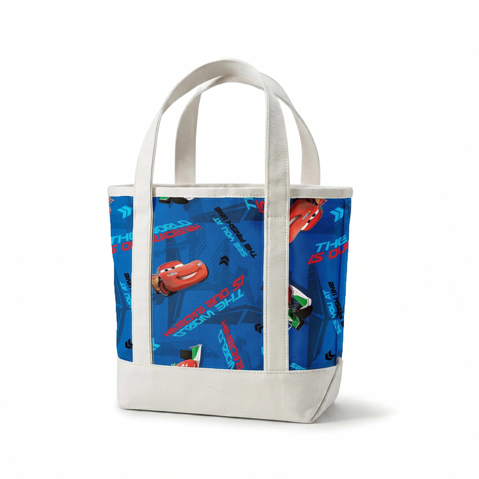Blue fabric pattern with animated red race cars, "The World of Cars" text, and directional arrow designs springs canvastote mockup