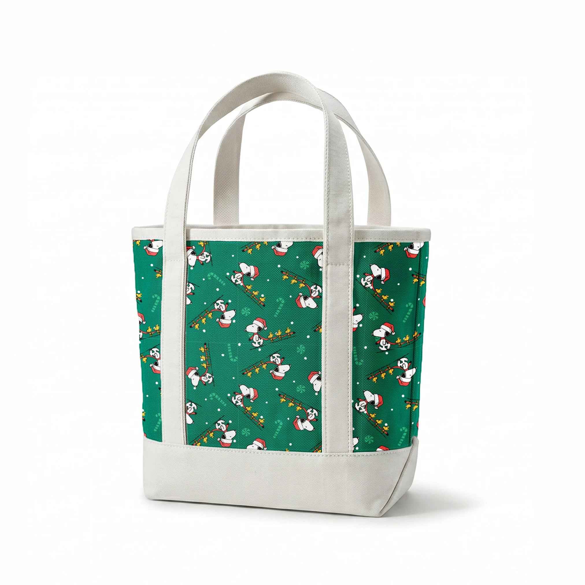 Holiday pattern with Snoopy in Santa hats pulling sleds of stars on green background with candy canes and snowflakes springs canvastote mockup