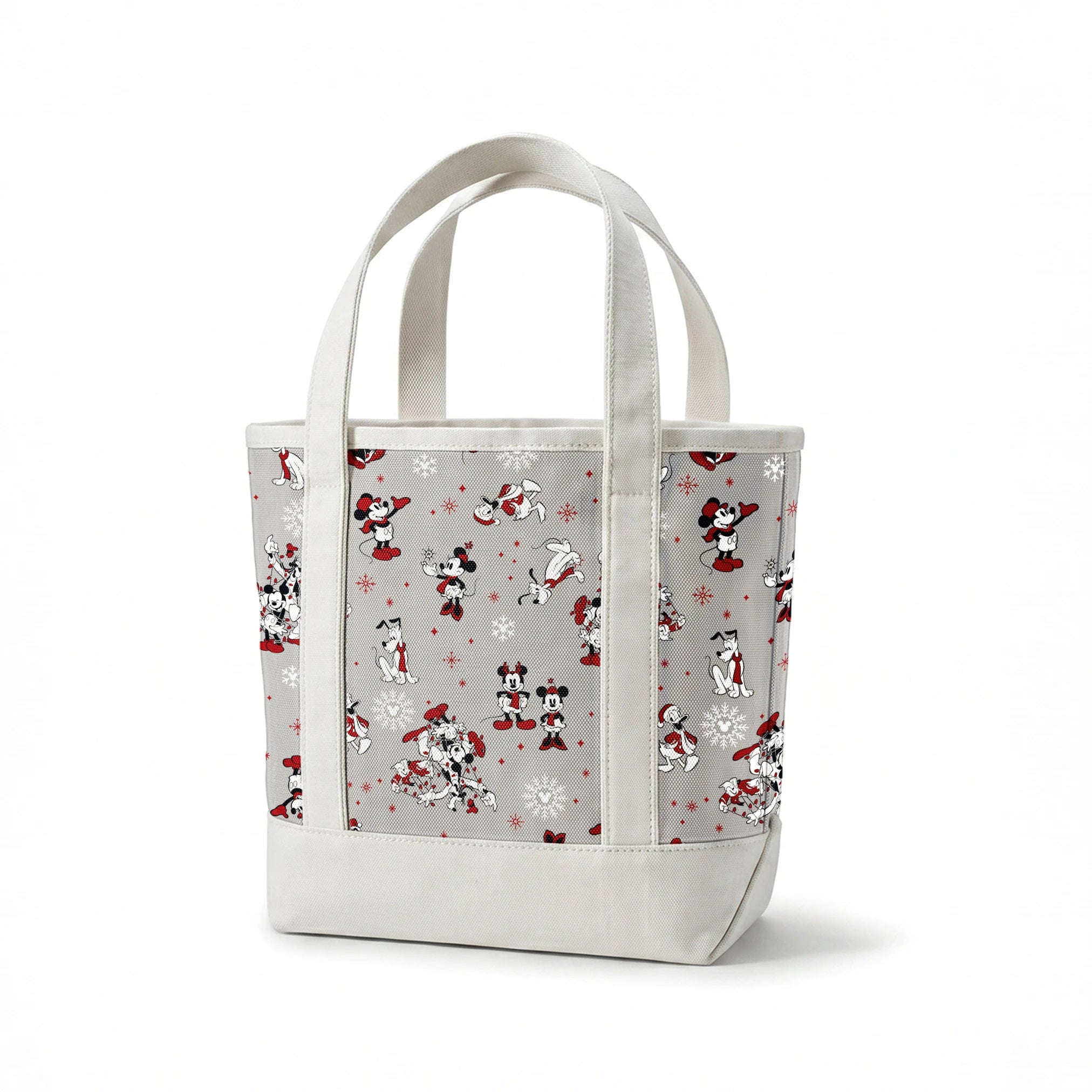 Mickey and Minnie Mouse characters in winter attire with snowflakes on gray background springs canvastote mockup