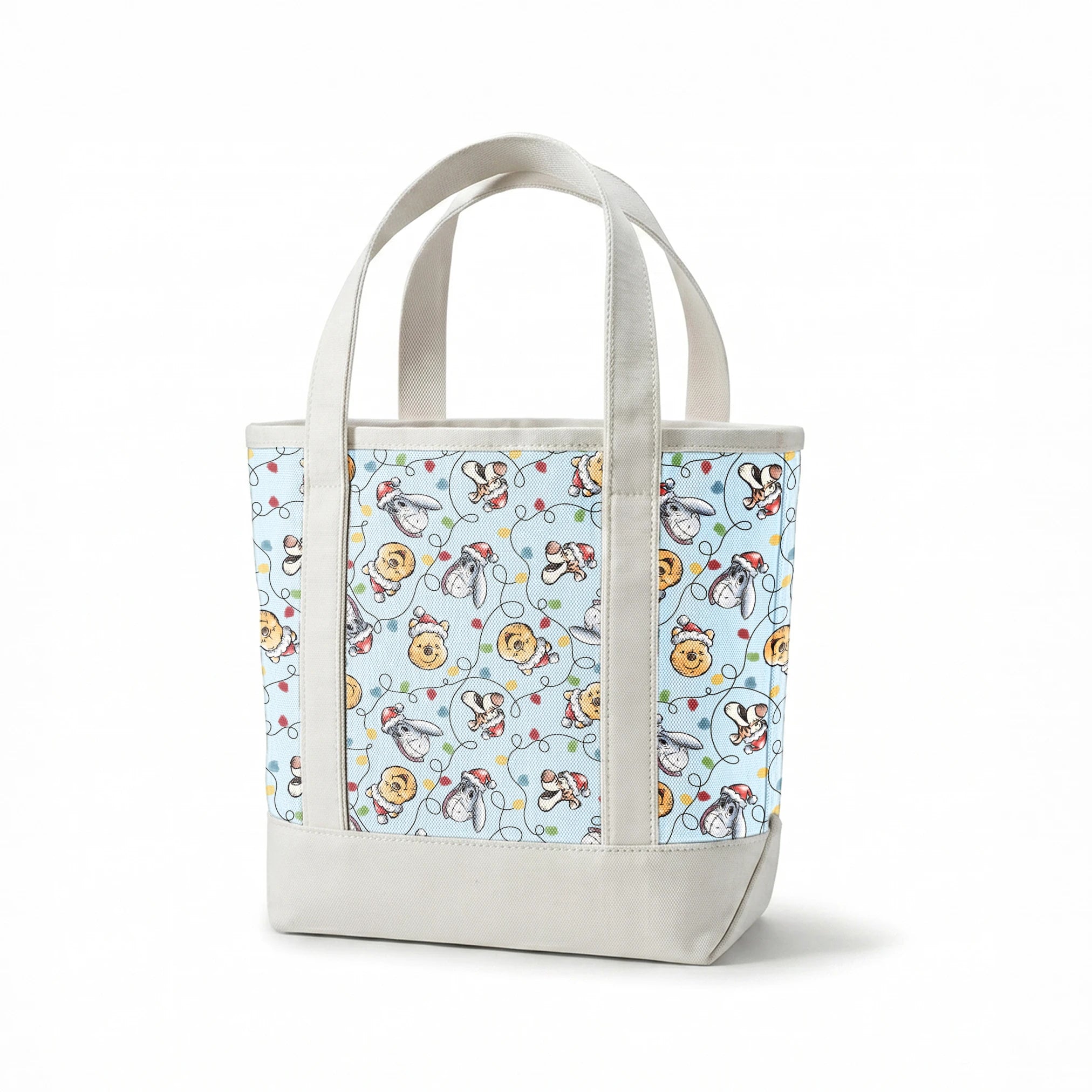 Winnie the Pooh Christmas pattern with Pooh bear, Eeyore, and Tigger in Santa hats on blue background springs canvastote mockup