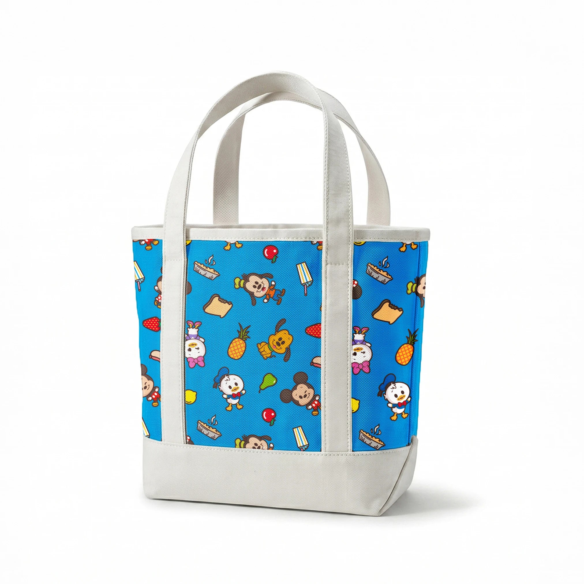 Mickey, friends, and food items pattern on blue background, featuring Mickey, Minnie, Donald, and fruit icons springs canvastote mockup