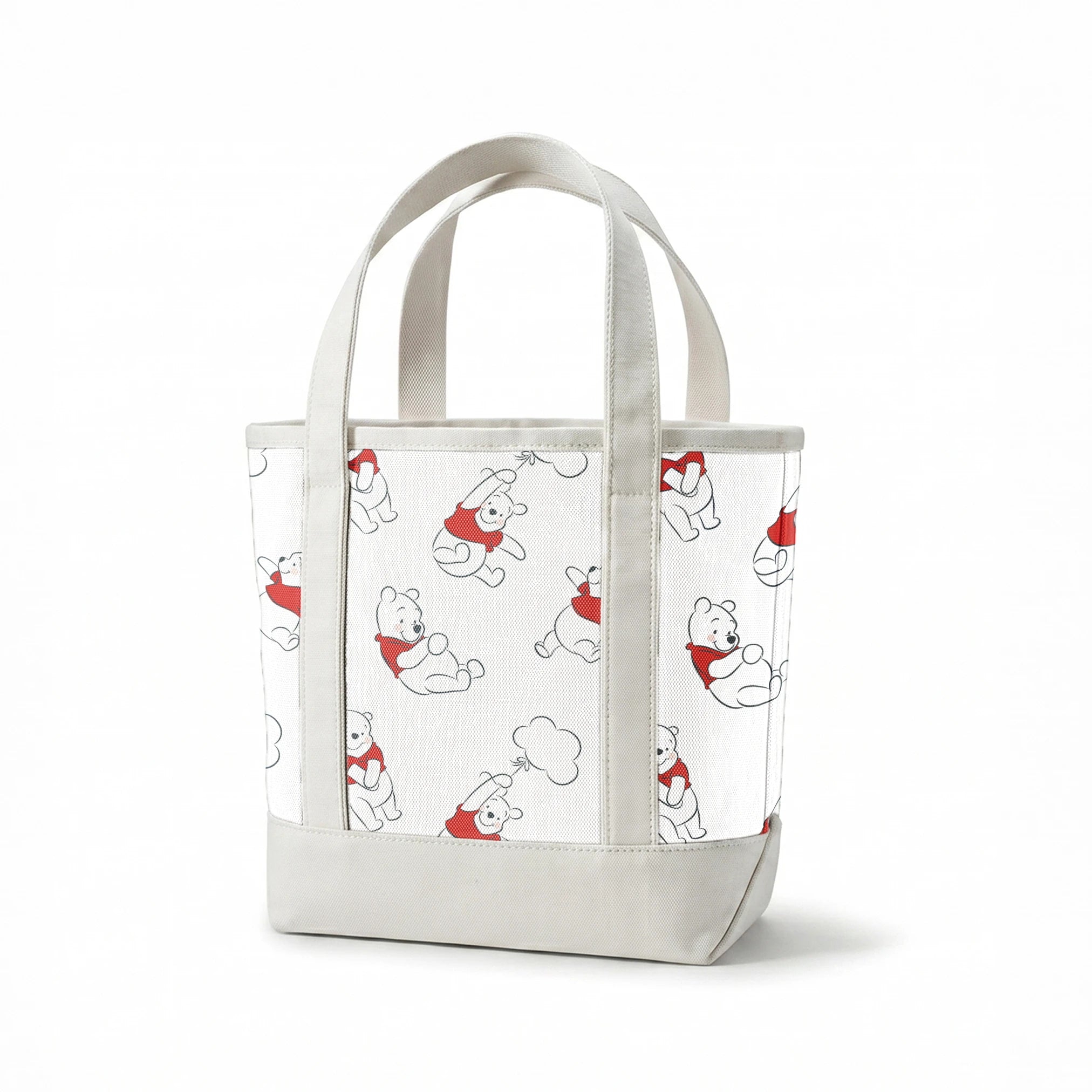 Illustration pattern of Winnie the Pooh in different poses wearing a red shirt on white background springs canvastote mockup