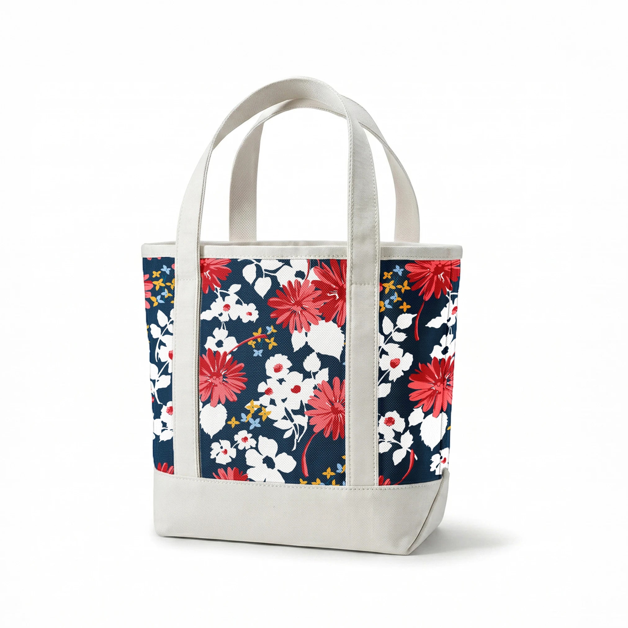 Vibrant floral pattern with red daisies and white flowers on navy background with small gold stars springs canvastote mockup