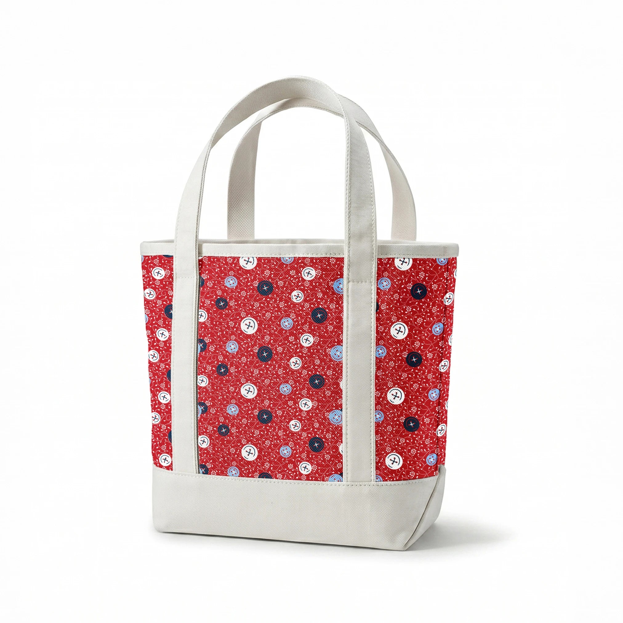 Red background with small white floral pattern featuring scattered button designs in blue, white, and navy cross details springs canvastote mockup